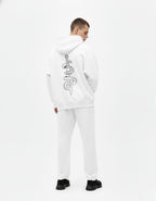 Back profile of a male model wearing the GENZs Fashion signature snake and dagger graphic hoodie in white.