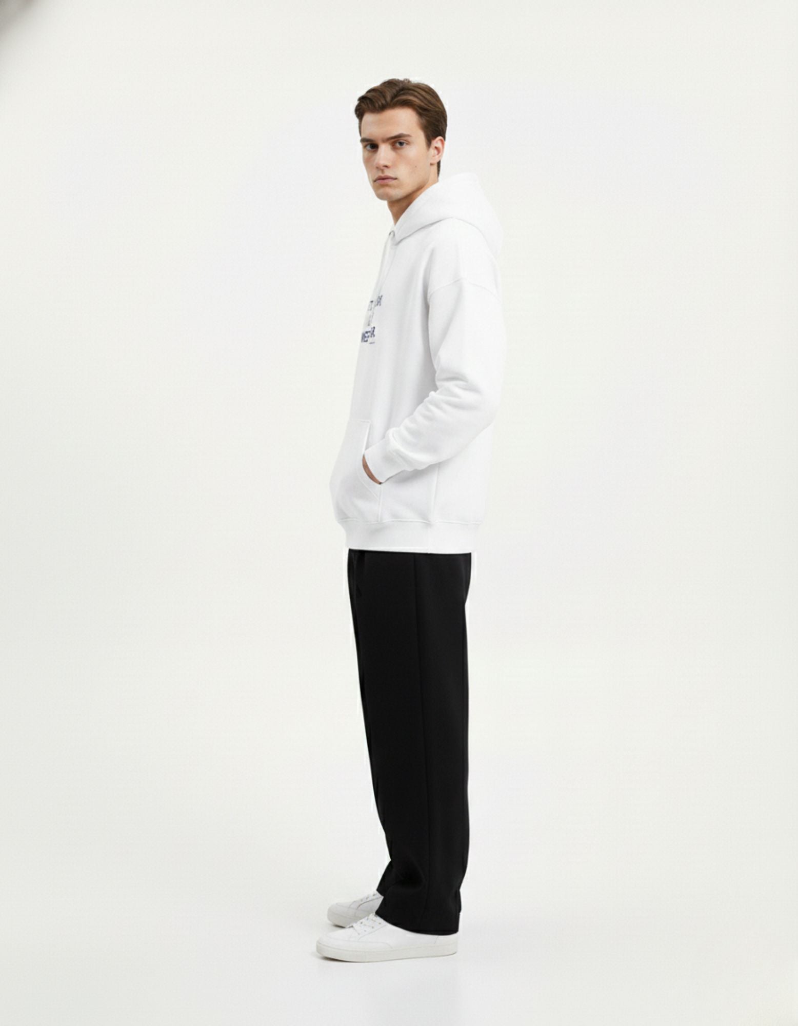 Side profile of a male model wearing a white GENZs Fashion graphic hoodie, showcasing the comfortable oversized fit.