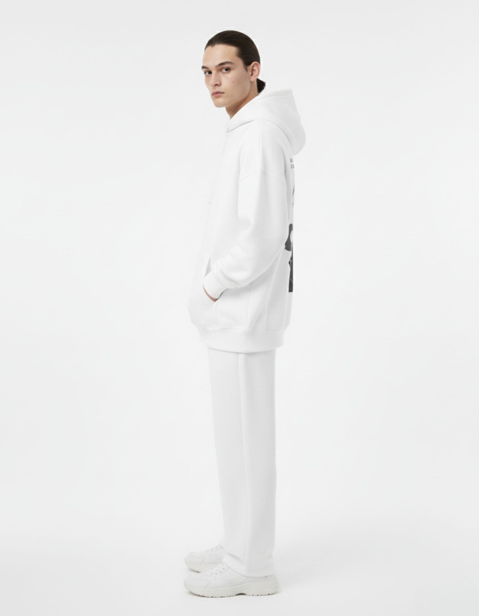 Side view of male model in a white oversized anime hoodie, premium cotton streetwear by GENZs Fashion.