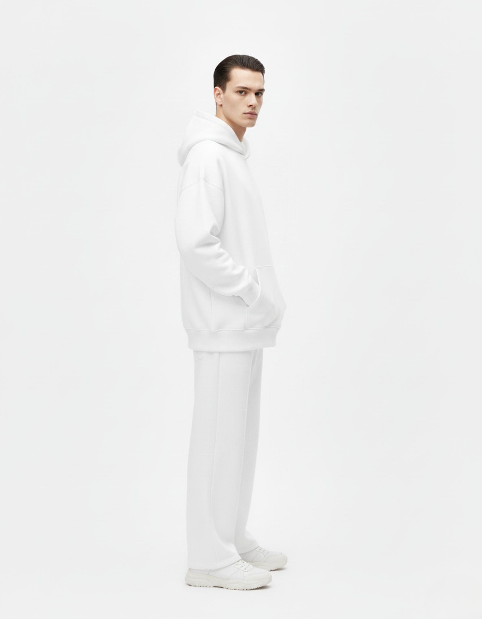 Male model wearing white GENZs Fashion anime-inspired hoodie, side profile showing oversized fit and back graphic.