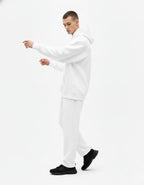 Side view of a male model wearing a premium white oversized hoodie and matching joggers set from GENZs Fashion streetwear collection.