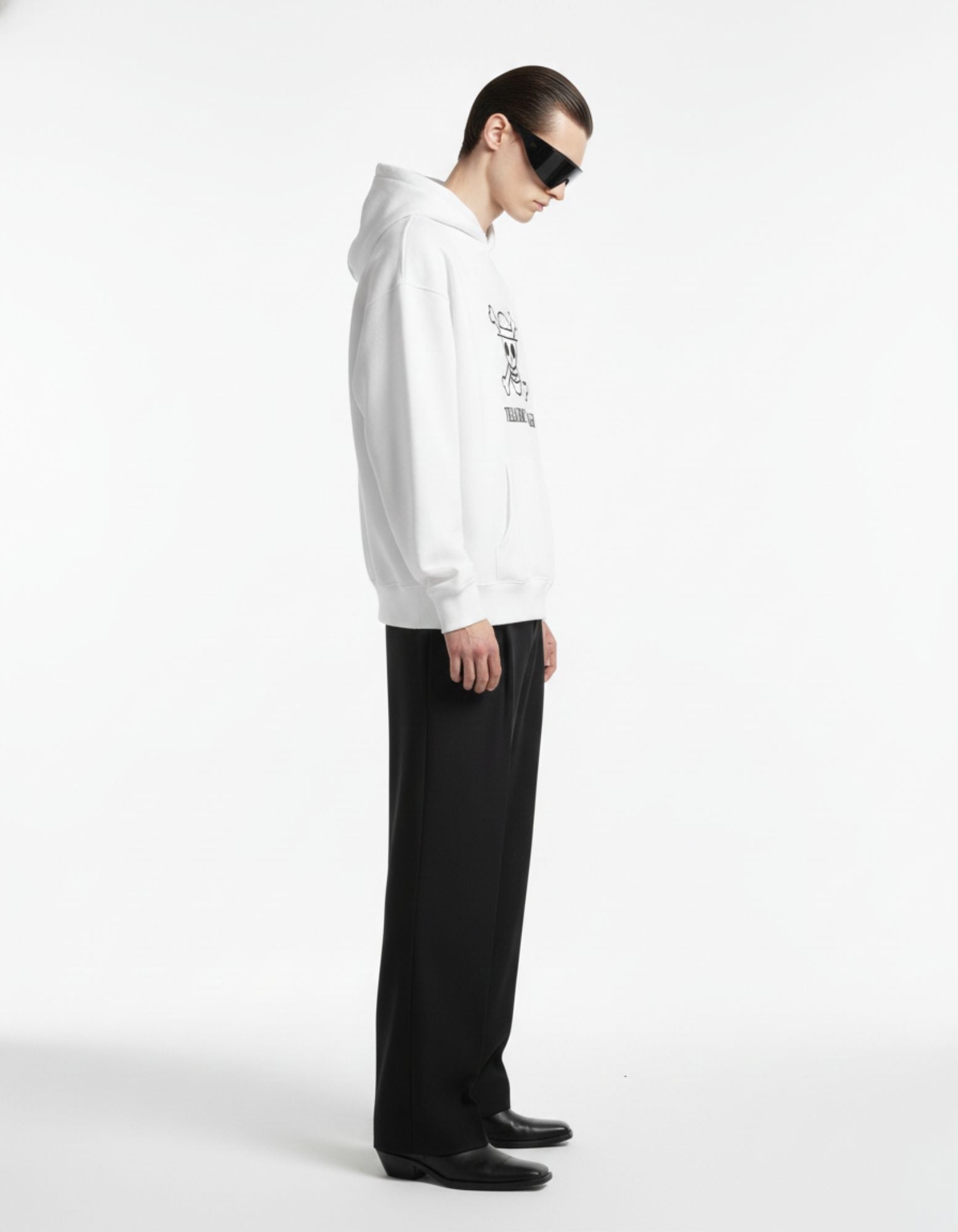 Side view of a white oversized graphic hoodie for men, showing the baggy drop-shoulder fit and high-quality cotton texture.