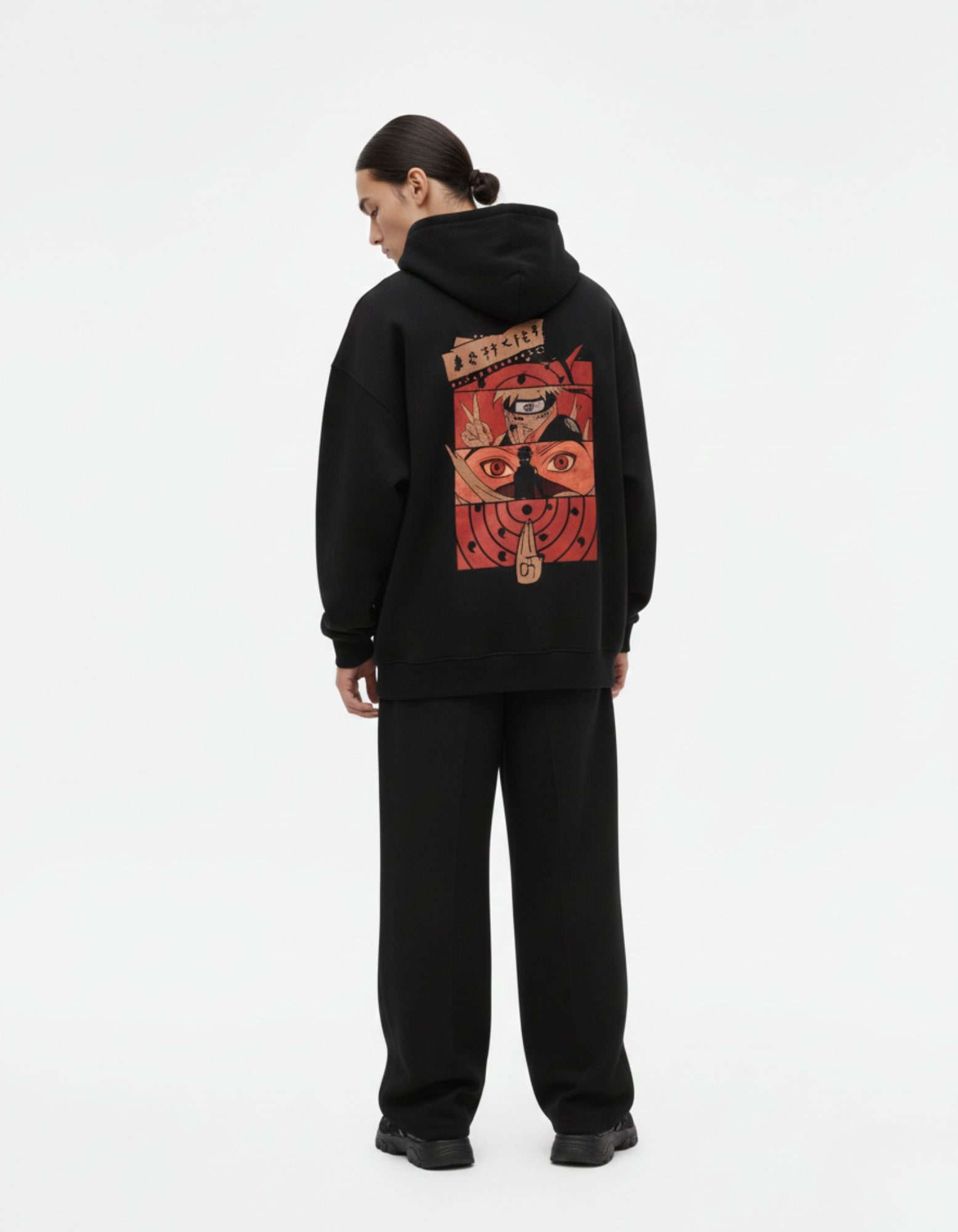 Detailed back view of a Naruto Shippuden anime graphic hoodie in black, featuring Kakashi and Sharingan eye aesthetics.