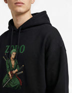 Close-up detail of the Roronoa Zoro character print on a premium black heavyweight cotton hoodie, highlighting the vibrant green accents.