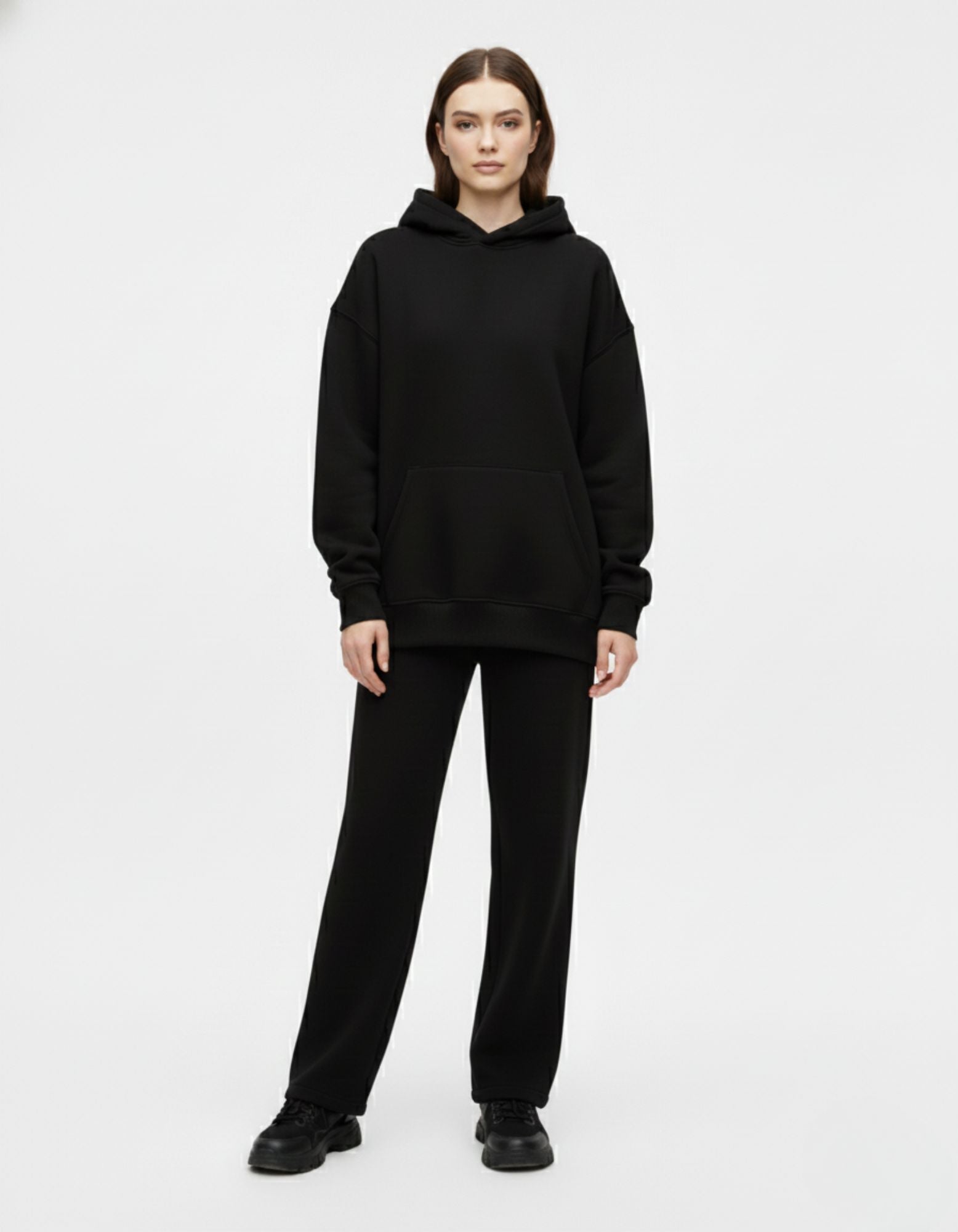 Front standing view of a female model in an oversized black heavyweight hoodie from GENZs Fashion, highlighting the clean front design.