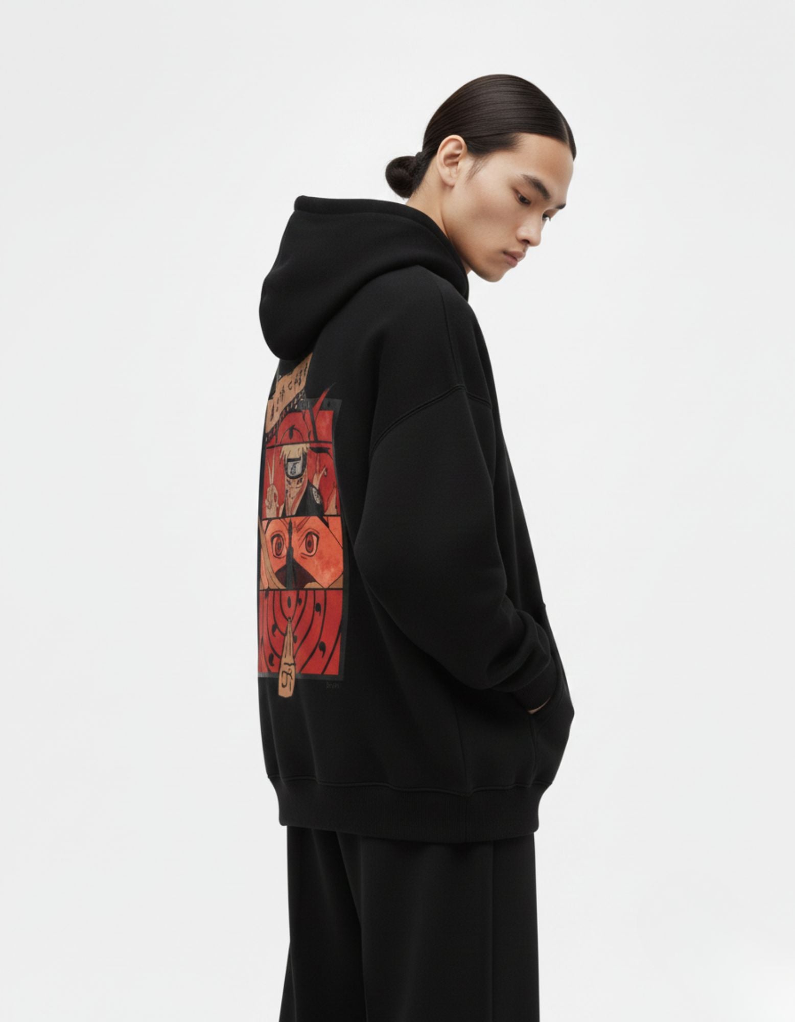 Male model wearing an oversized black Naruto-inspired hoodie from GENZs Fashion, showcasing a bold anime panel print.