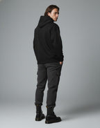 Back view of black oversized hoodie showing clean plain back design