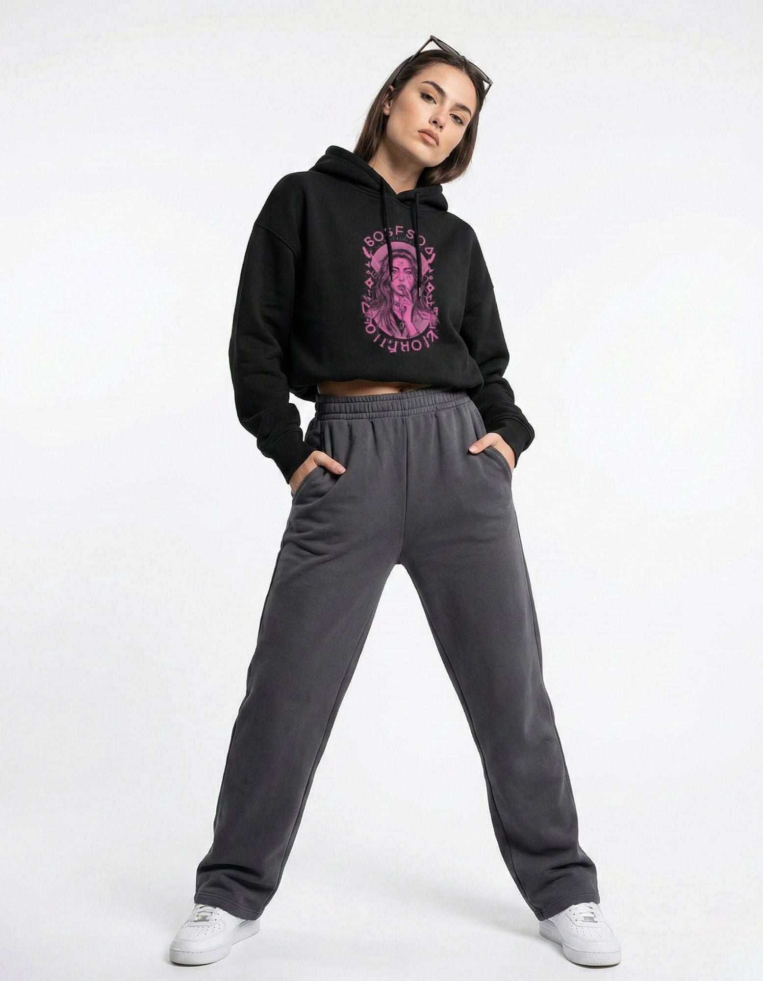 Front view of black oversized hoodie with pink graphic print worn by female model