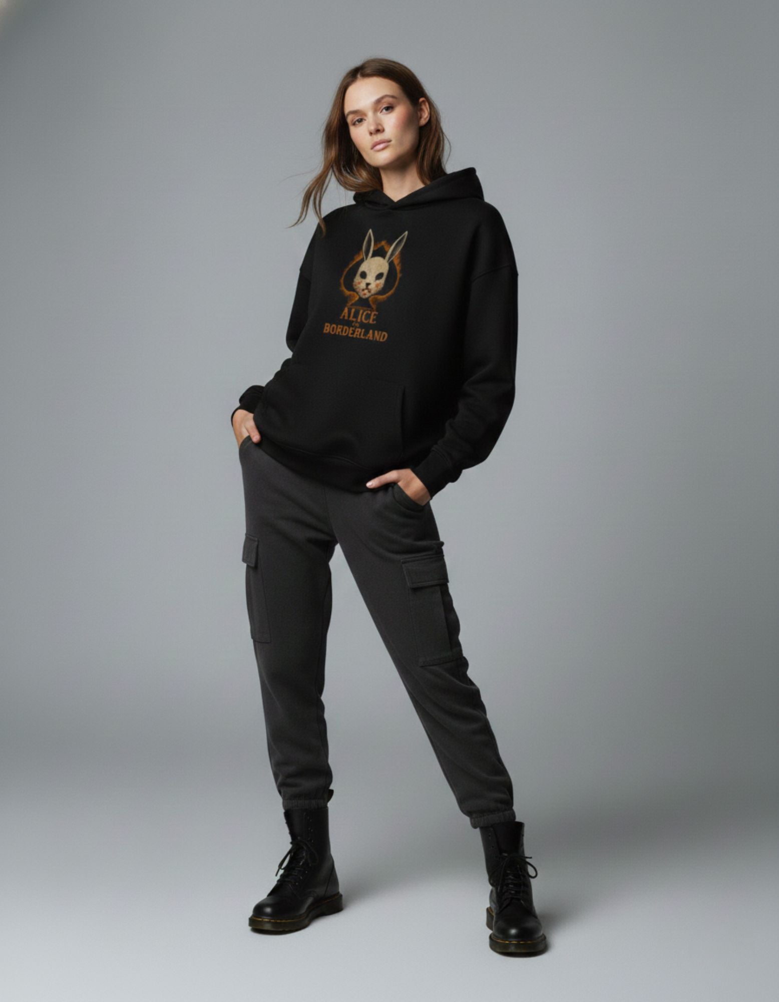 Front view of black oversized hoodie with graphic print worn by female model