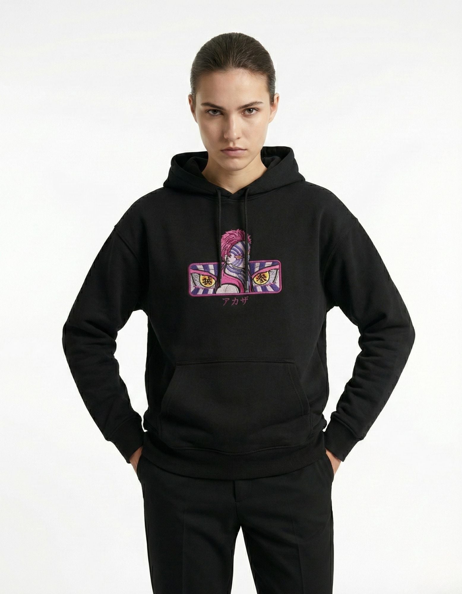 Front view of black oversized hoodie featuring anime graphic worn by female model