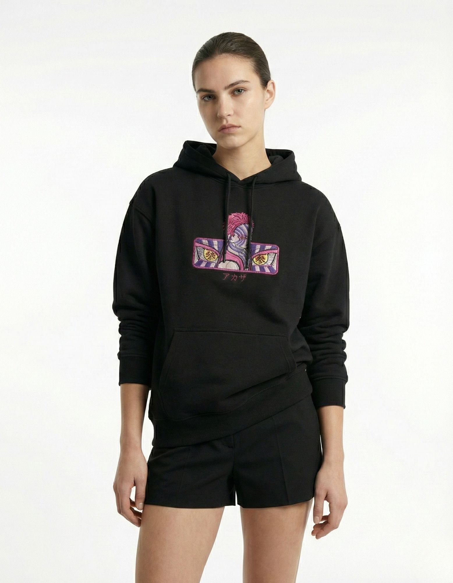 Lifestyle front view of black oversized hoodie with anime graphic design
