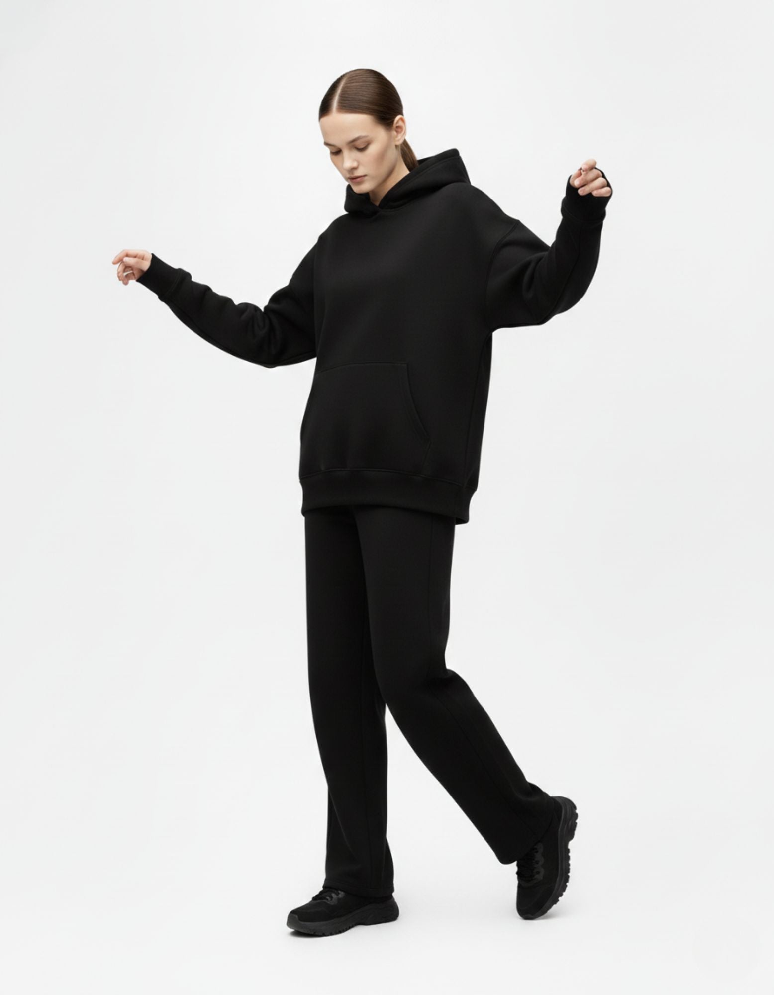 Model wearing black oversized hoodie in streetwear style by Genzs Fashion