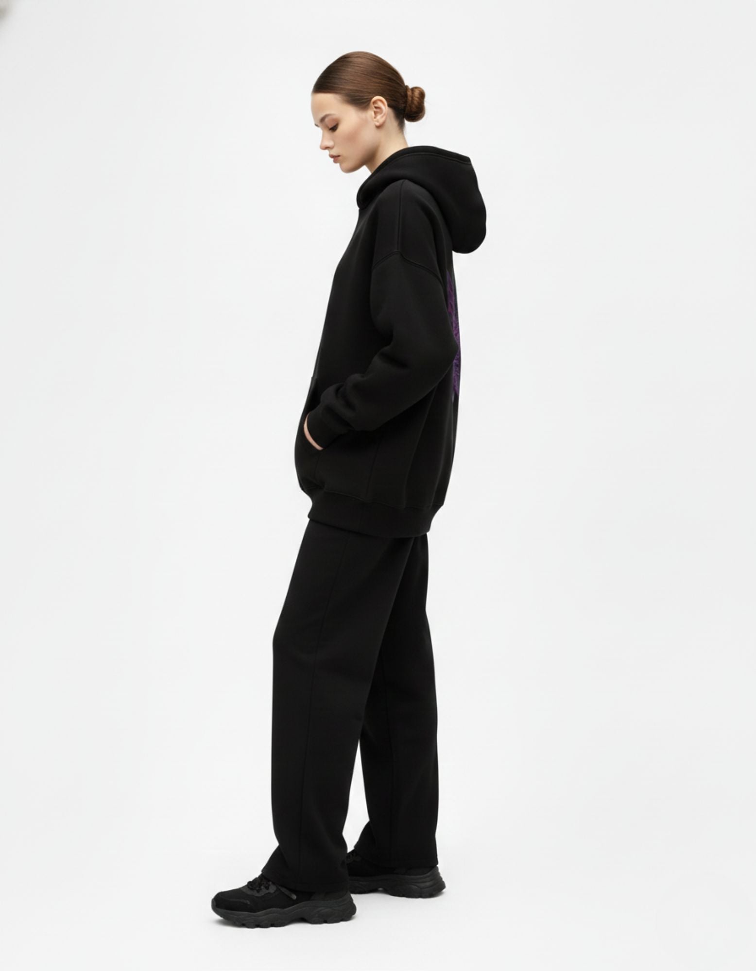 Side view of black oversized hoodie showing relaxed oversized fit