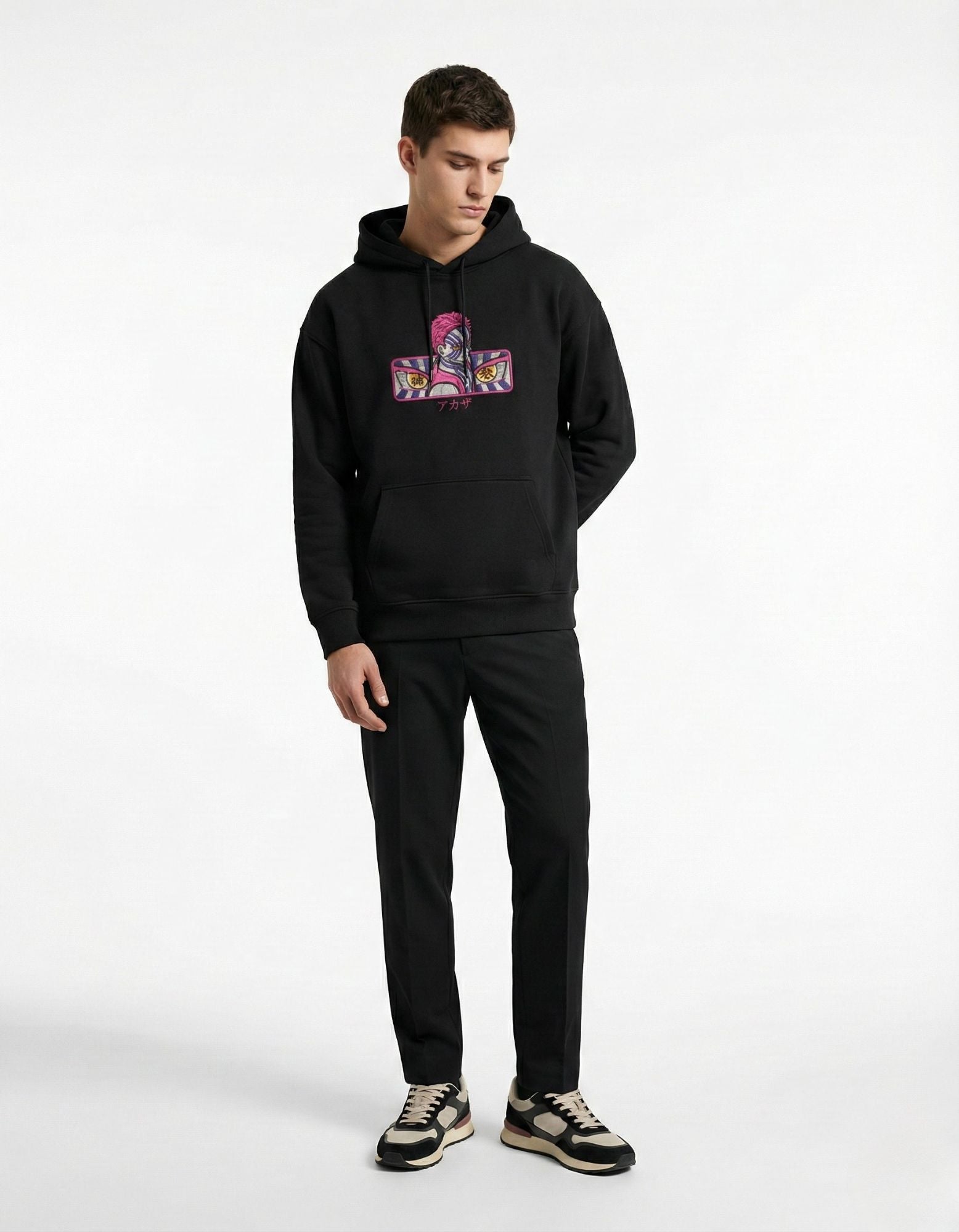 Front view of black oversized hoodie with anime graphic print worn by male model