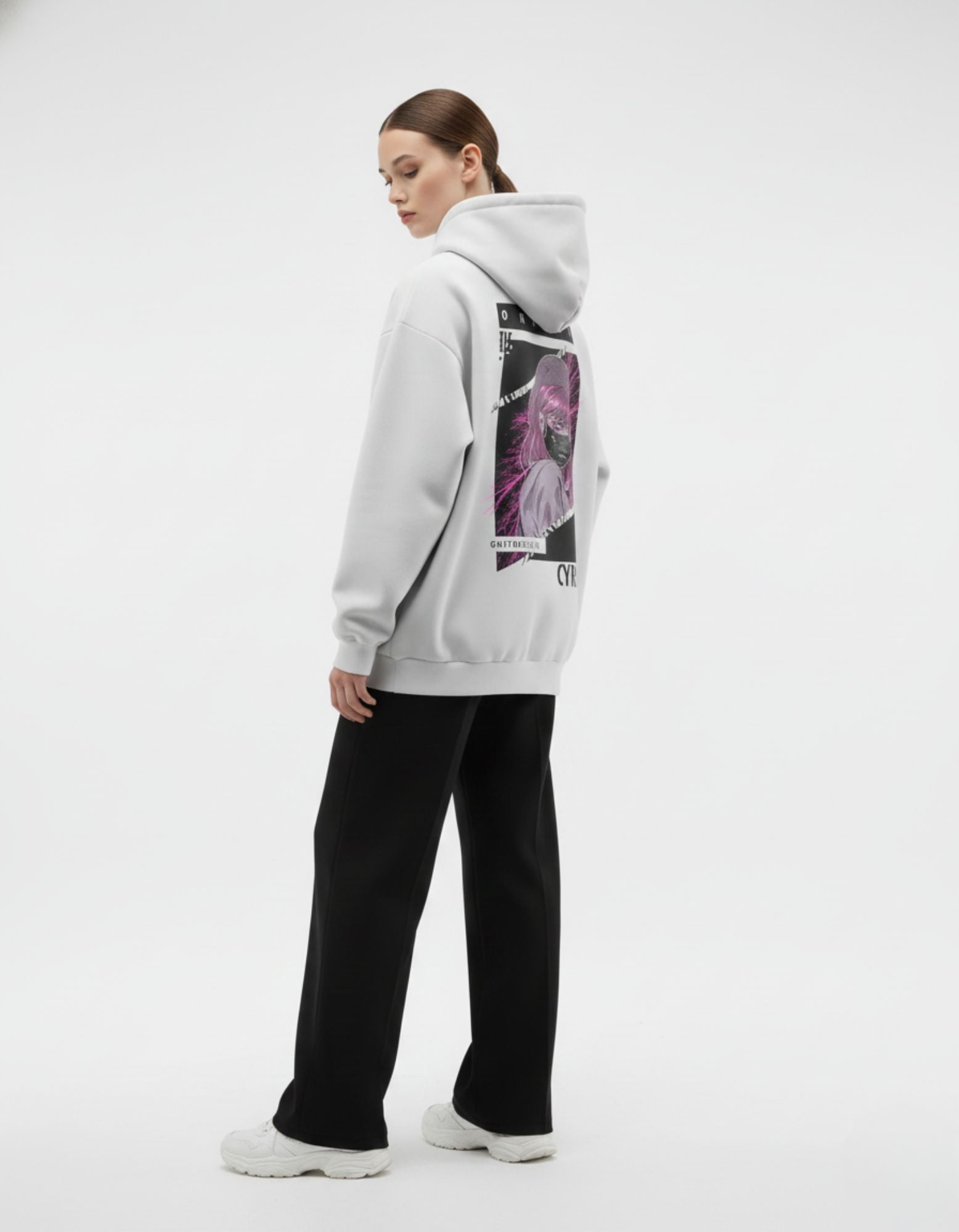 Angled back view of light grey oversized hoodie showing anime graphic design
