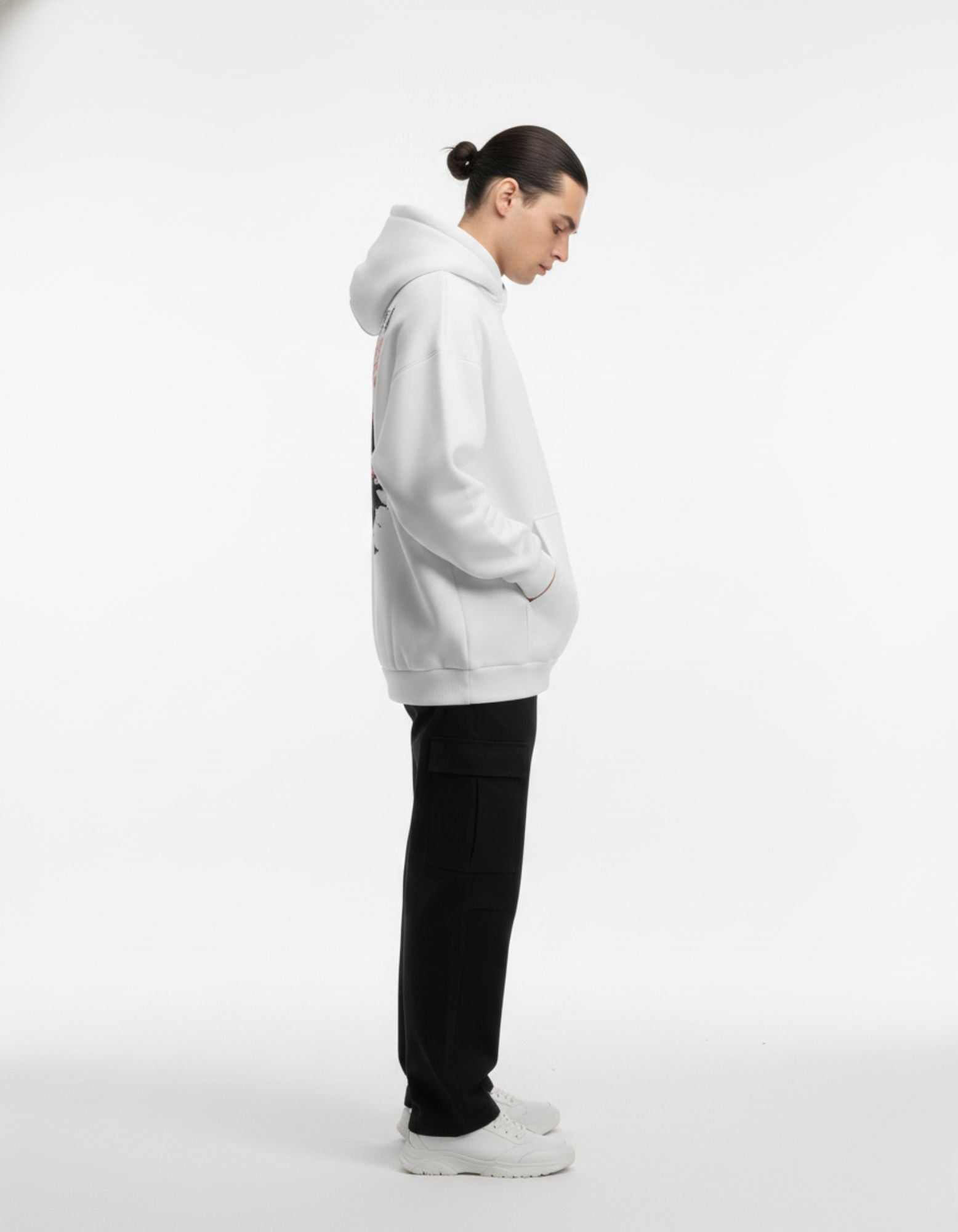 Side profile of light grey oversized hoodie worn by male model

