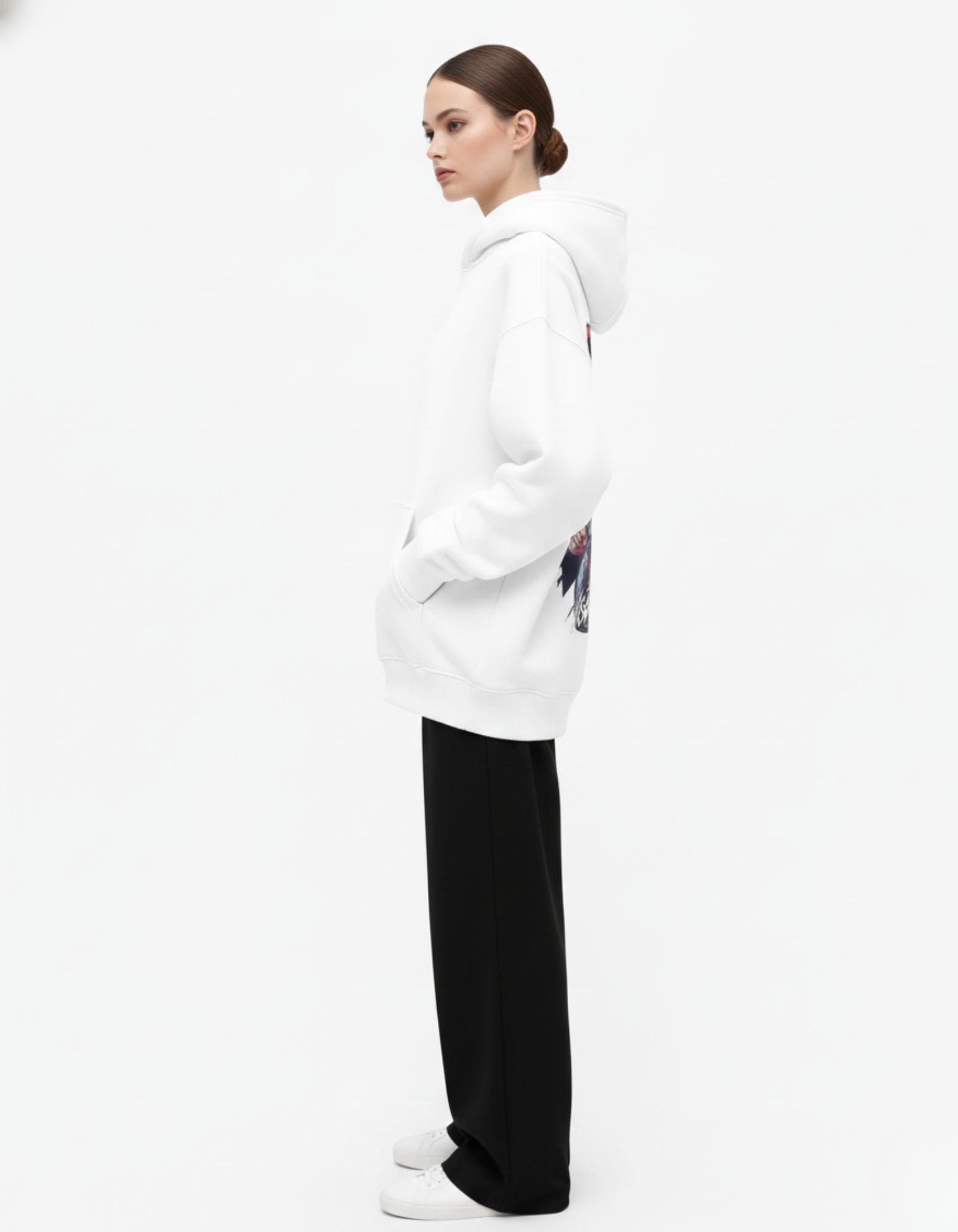 Side profile of white oversized hoodie worn by female model
