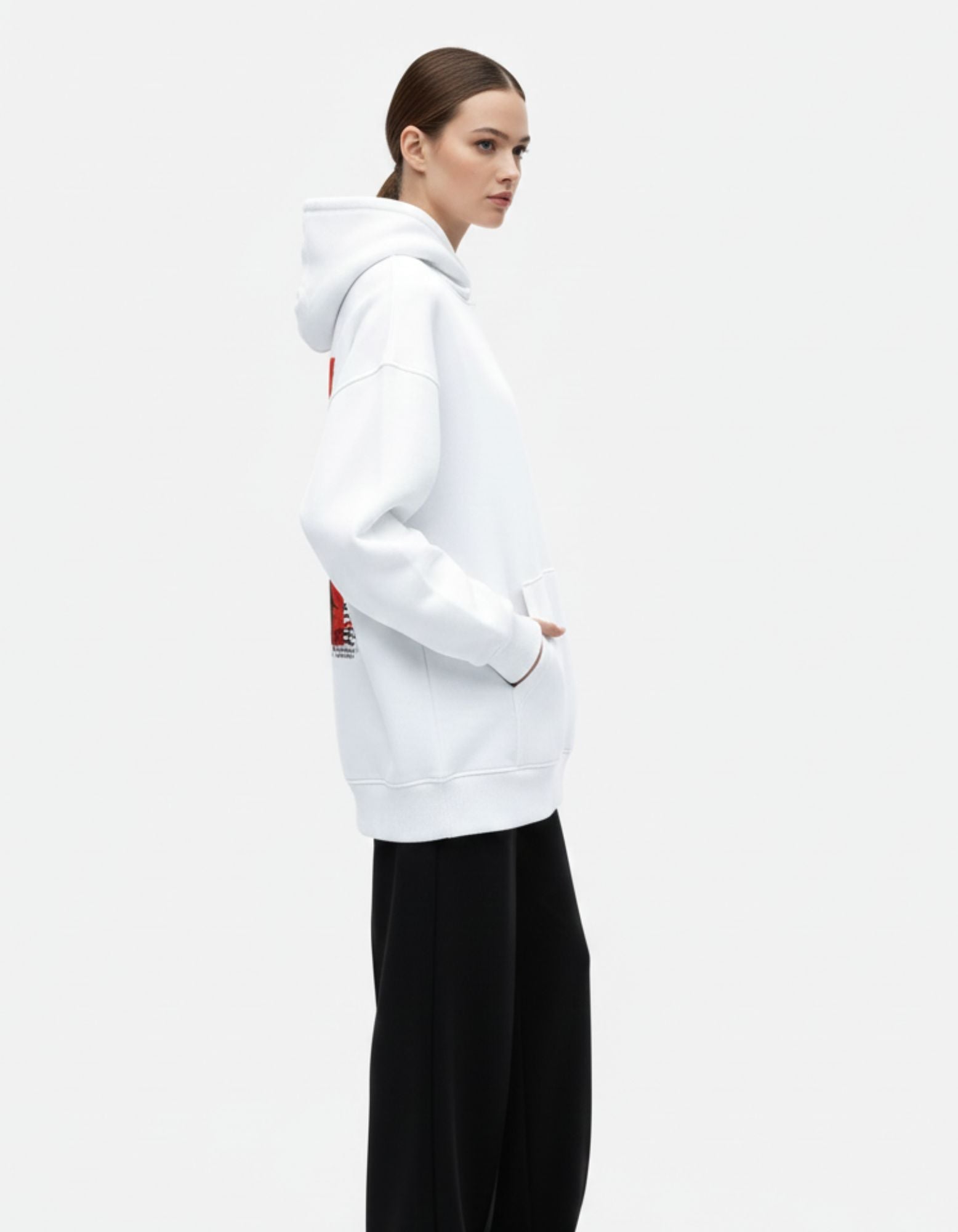 Side profile of white oversized hoodie worn by female model
