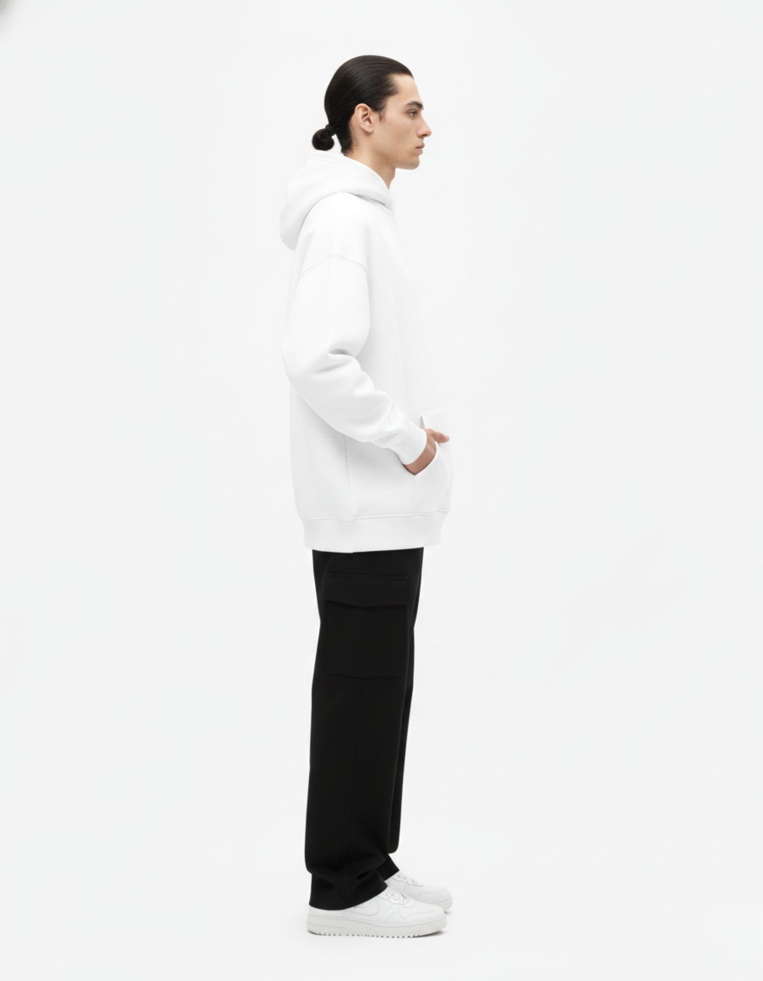 Side profile of white oversized hoodie showing relaxed oversized fit