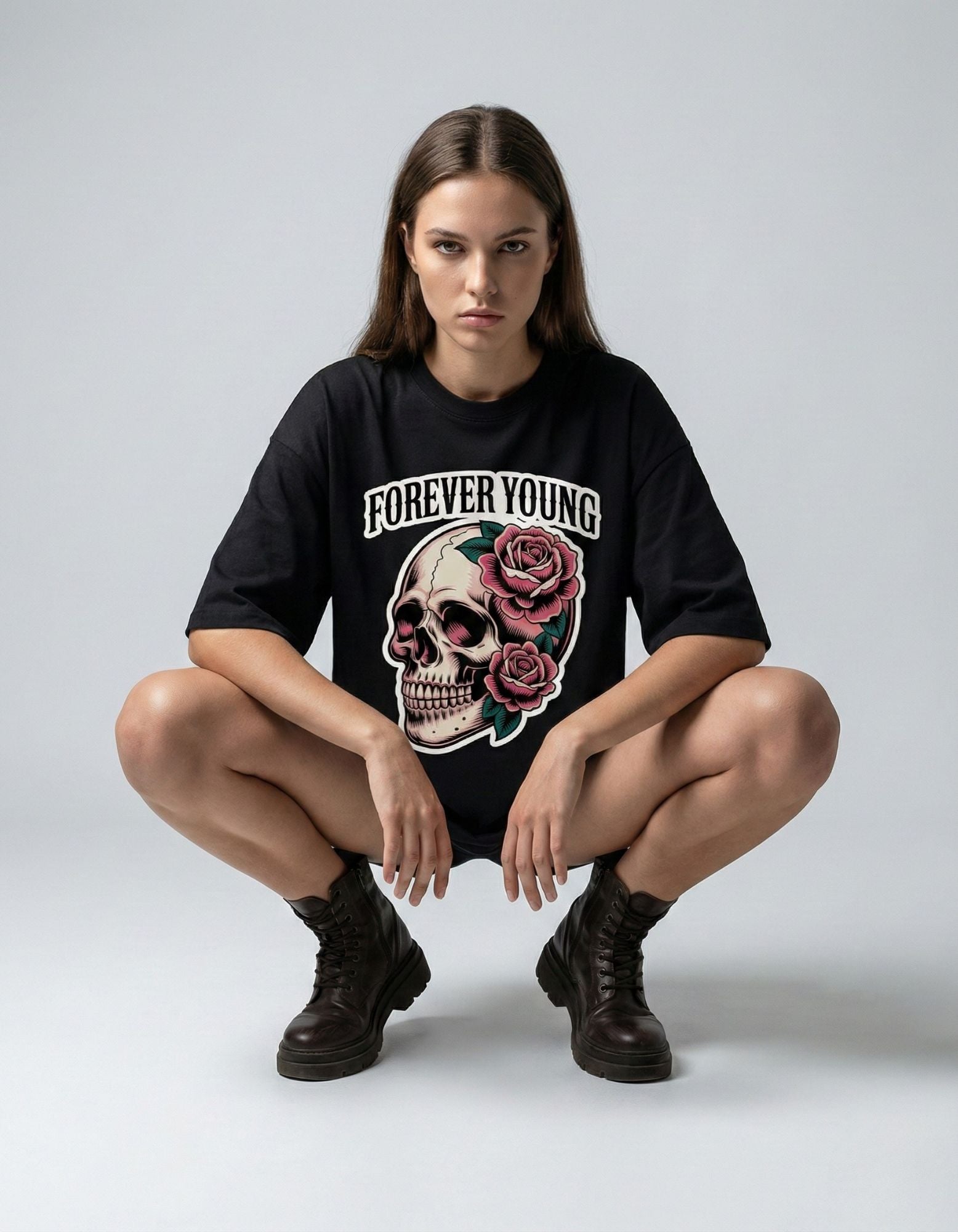 Front view of a woman wearing a black oversized t-shirt with Forever Young skull graphic from GENZY.