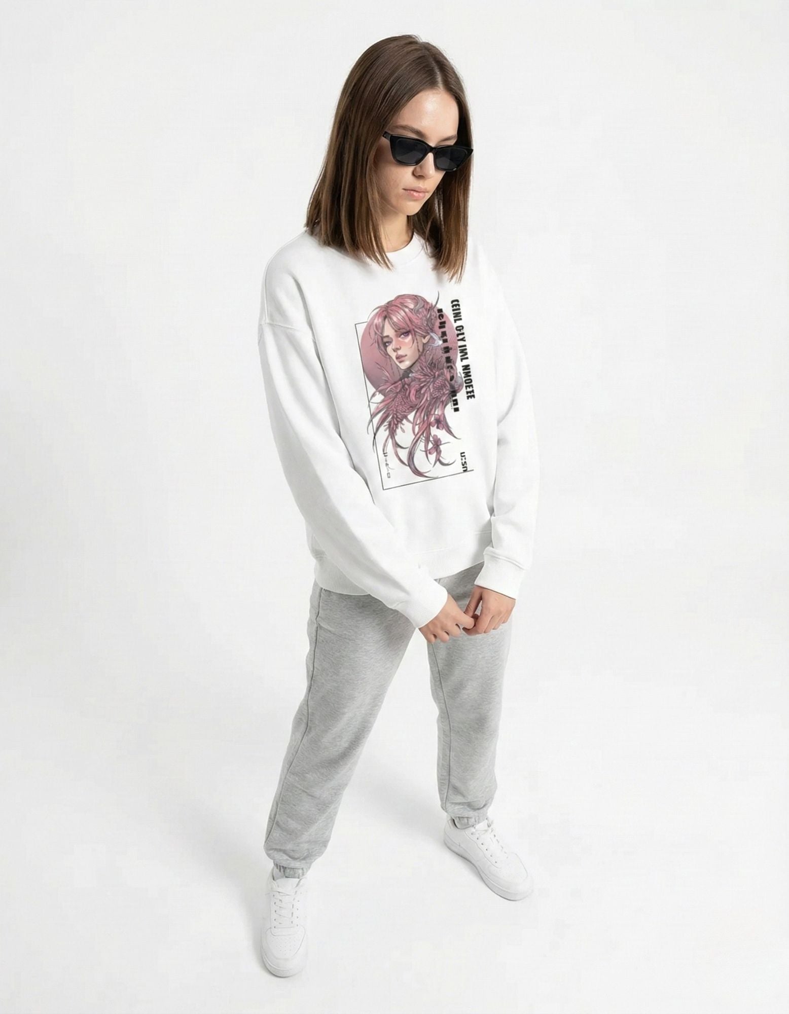Front view of a model wearing a white crewneck sweatshirt with a pink-haired manga girl illustration and grey sweatpants.