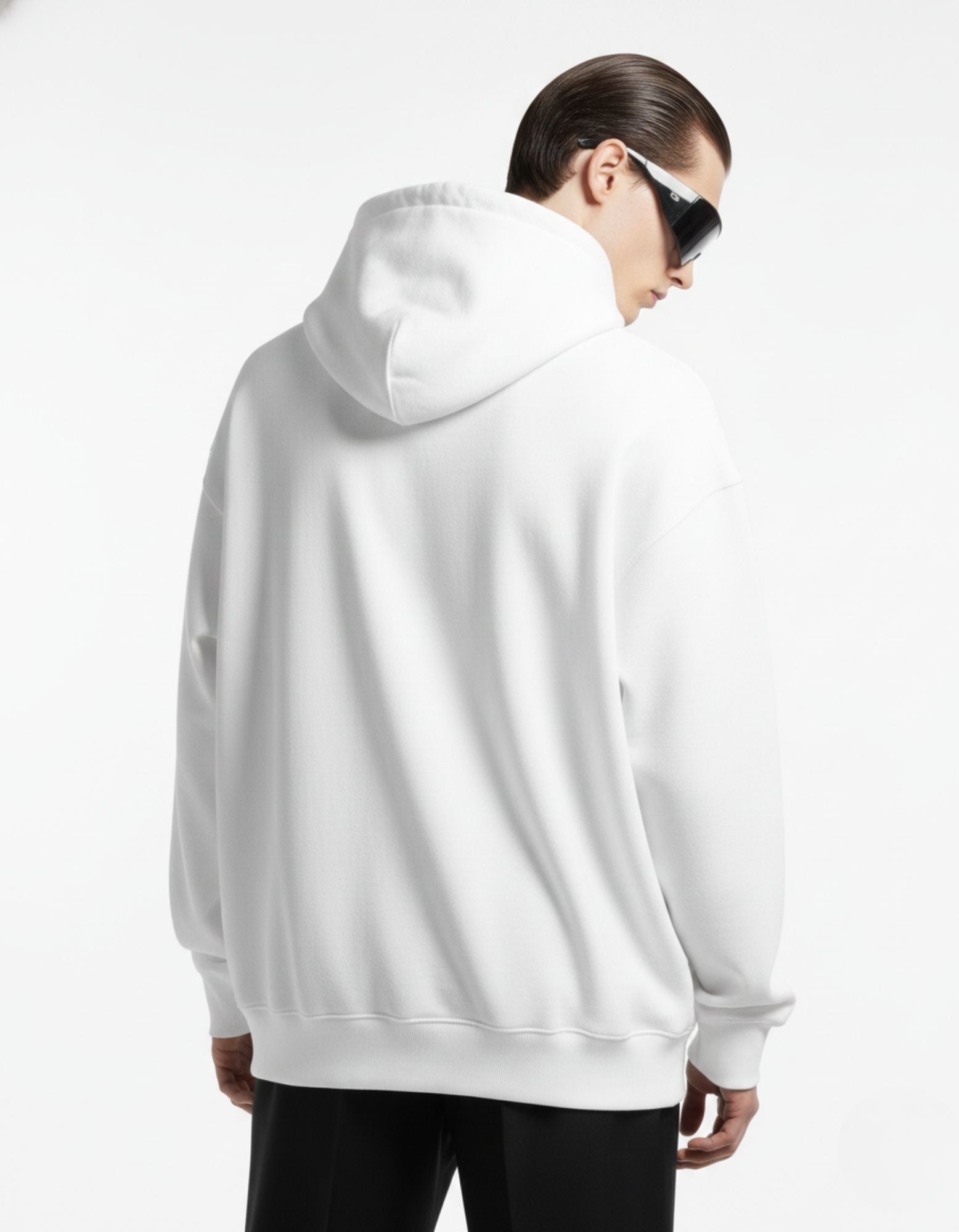 Back view of a minimalist white oversized hoodie, highlighting the clean design and premium streetwear silhouette.