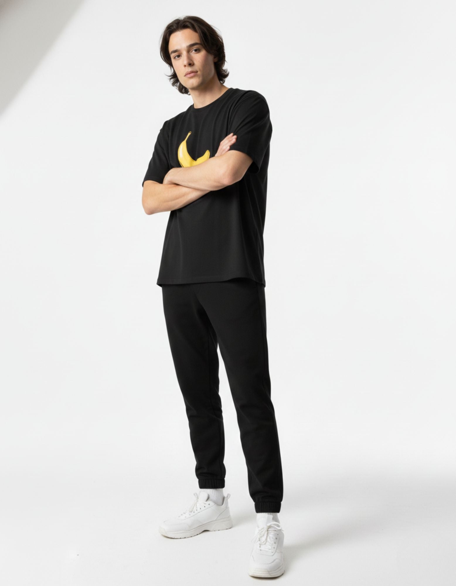 Front view of a premium cotton black streetwear shirt featuring a minimalist yellow banana design.