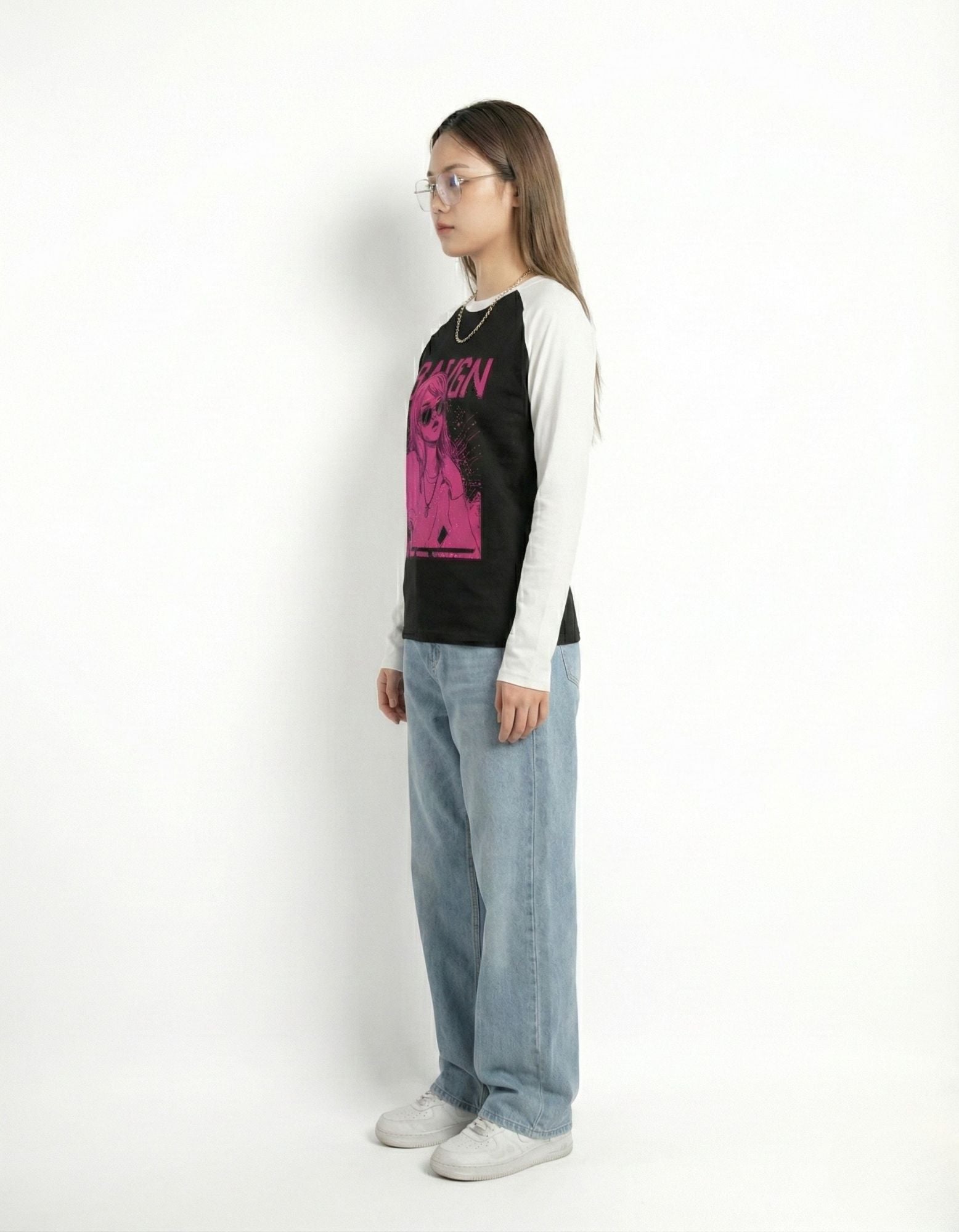 Side profile view of a slim-fit raglan long-sleeve shirt with contrast sleeves and pink graphic design.