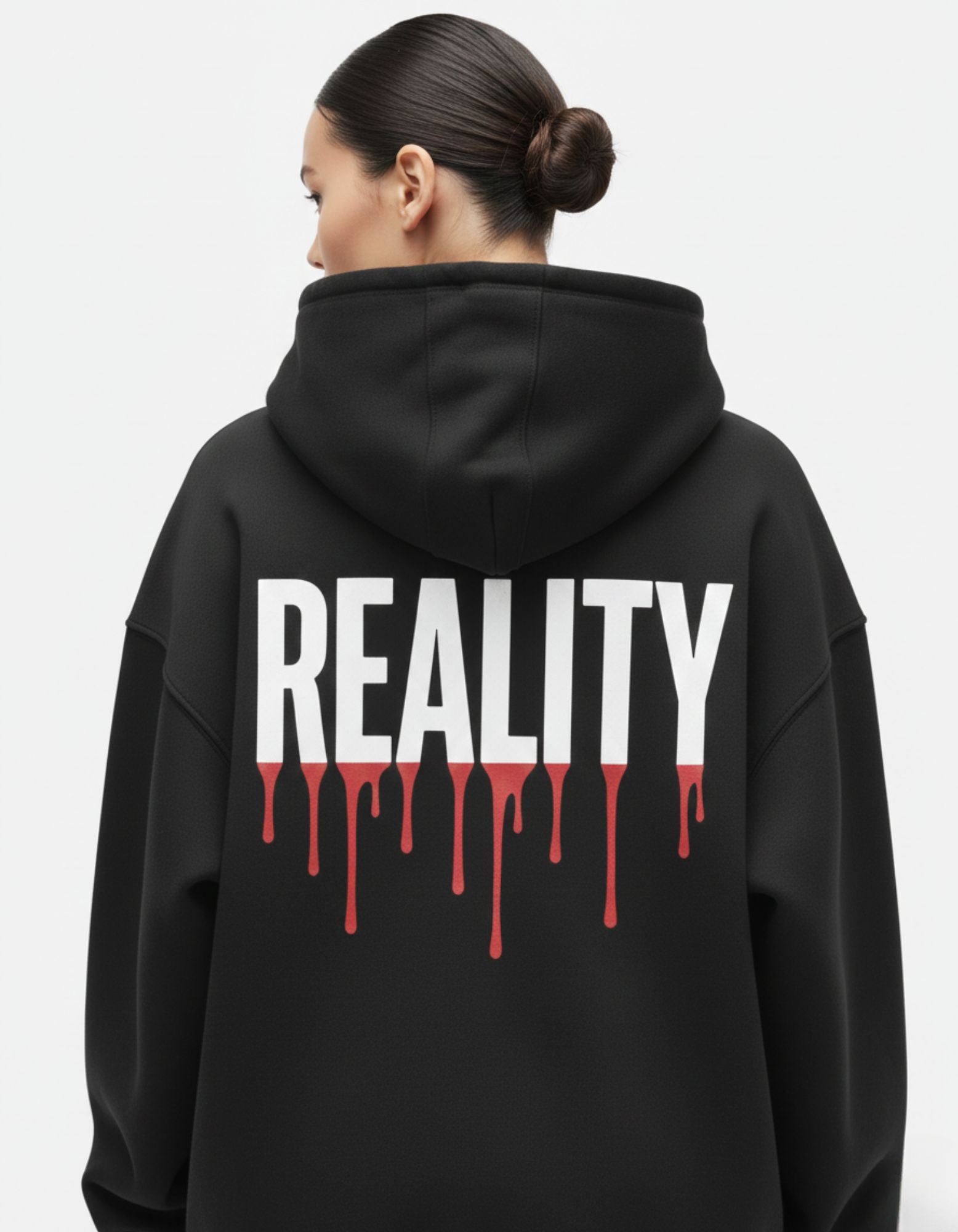 "Detailed close-up of the 'REALITY' text graphic with red paint drip design on a high-quality black GENZs Fashion hoodie."
