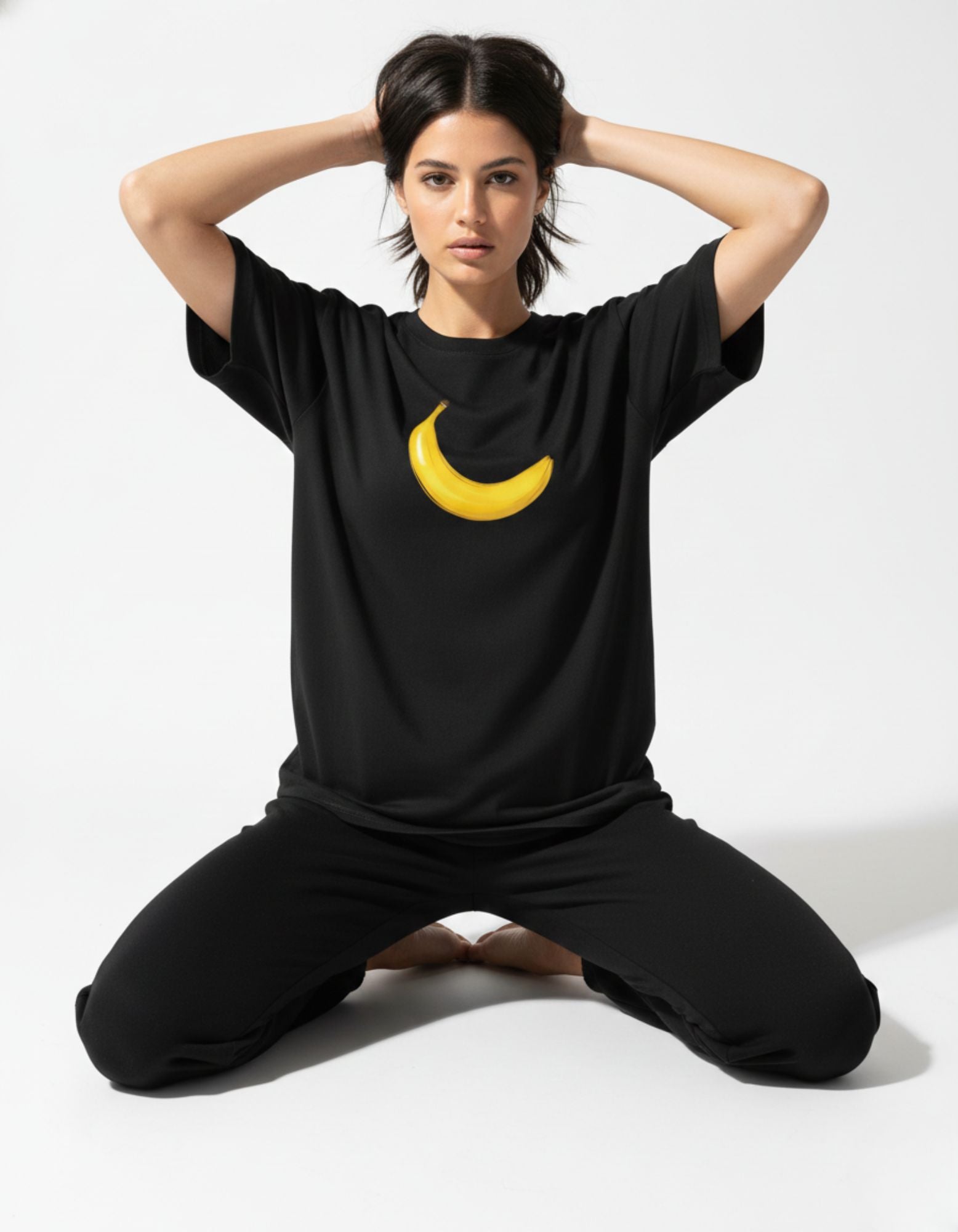 Relaxed fit black graphic tee with a yellow banana motif, perfect for a Gen Z casual streetwear look.