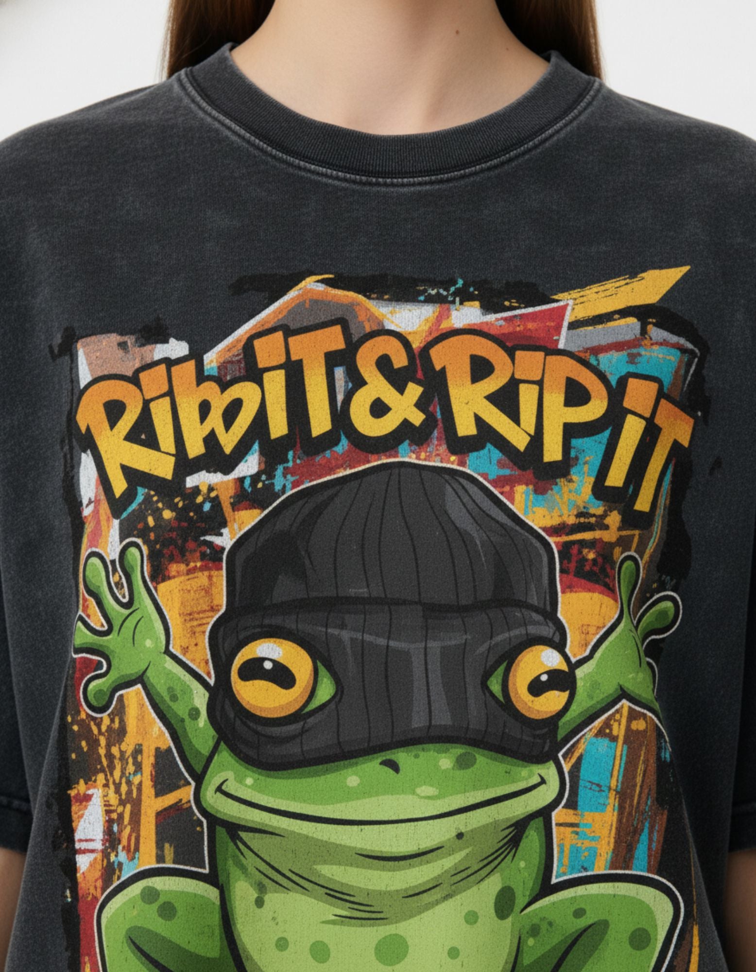 Close-up of the "RIBIT & RIP IT" frog on a skateboard graphic on a vintage charcoal streetwear t-shirt from GENZs Fashion.