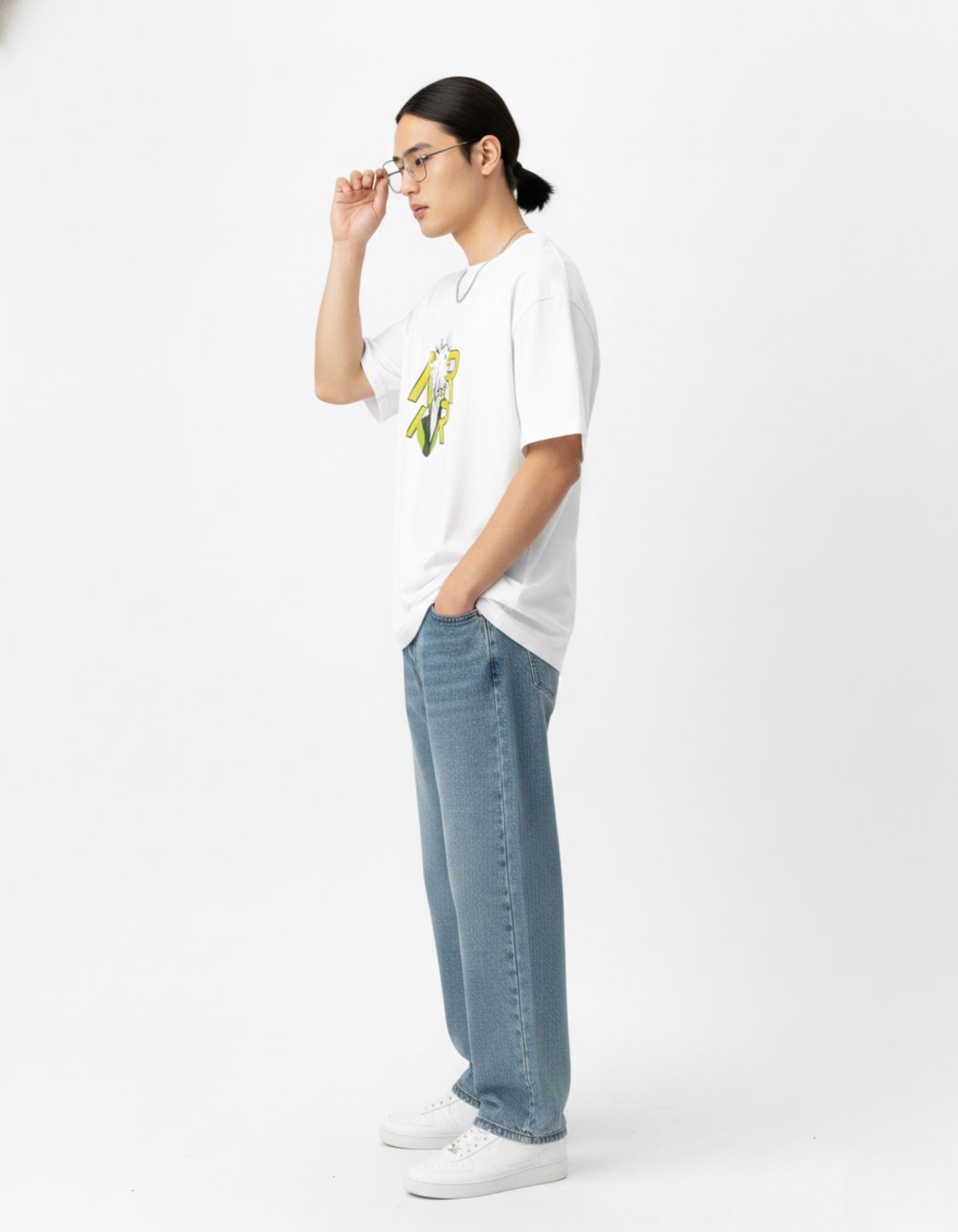 "Side view profile of a model wearing an oversized anime streetwear tee and blue baggy jeans from GENZs Fashion."
