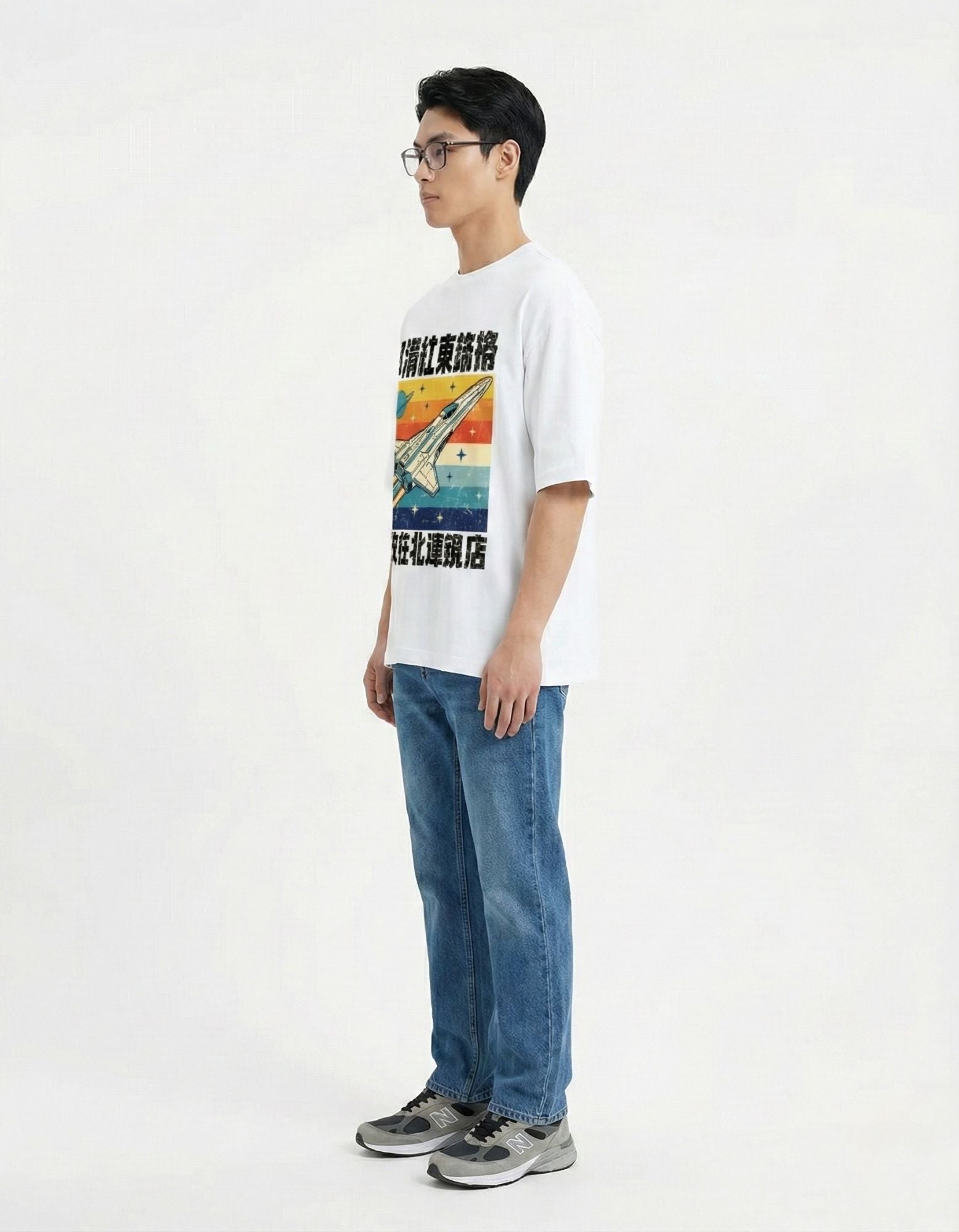 "Side view of white oversized t-shirt featuring a retro spaceship graphic, premium cotton streetwear for men."
