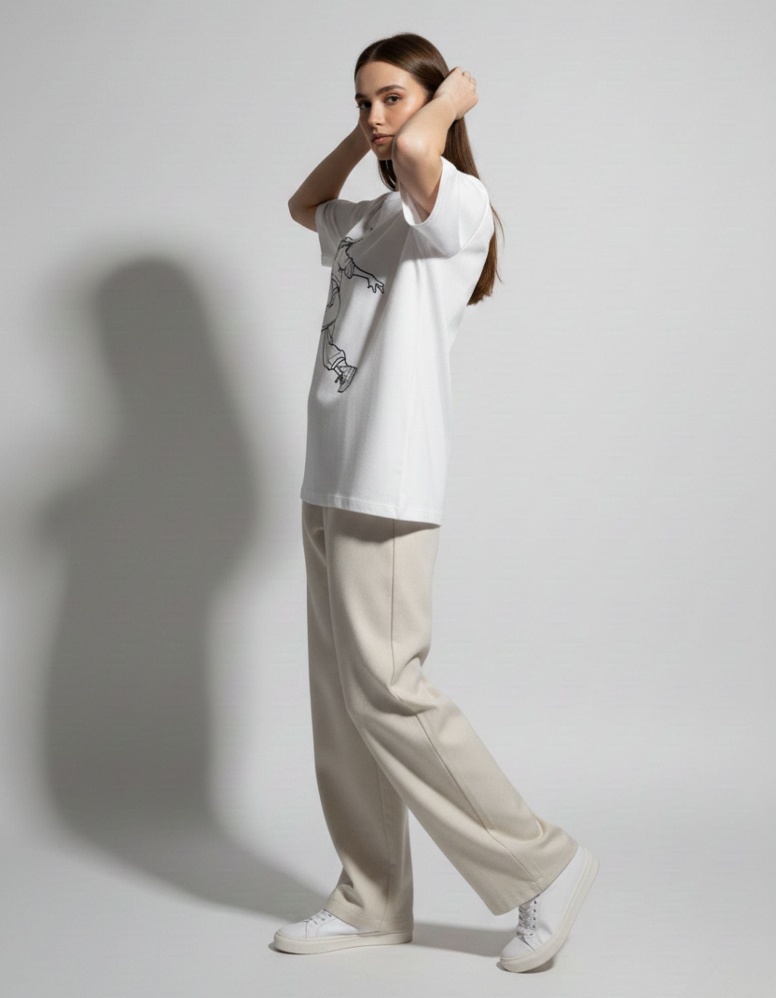 Side view of a white graphic streetwear tee showing the drop-shoulder fit and high-quality finish for the Indian market.