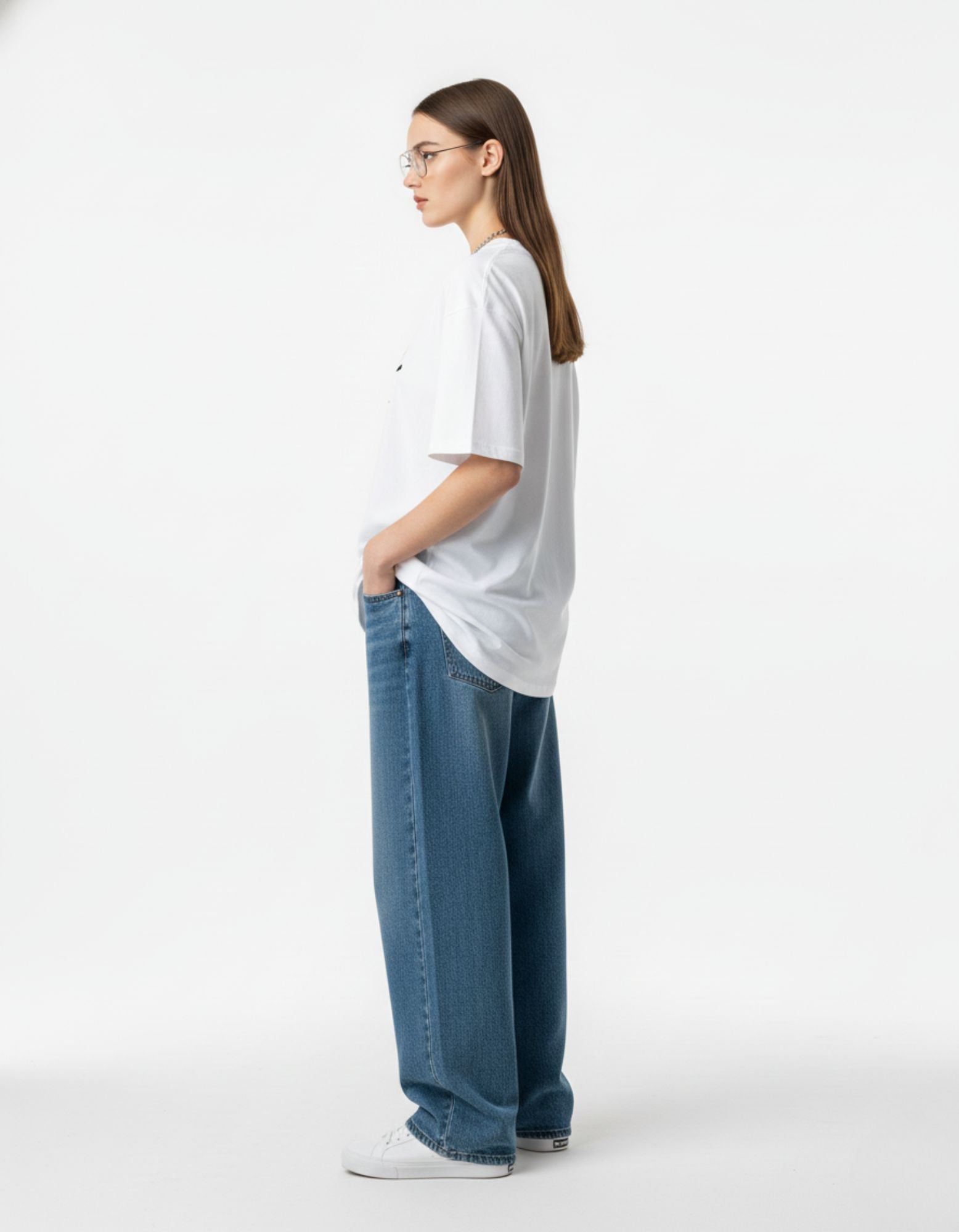 Side profile of woman wearing white oversized t-shirt, high-quality cotton streetwear for women available in India.