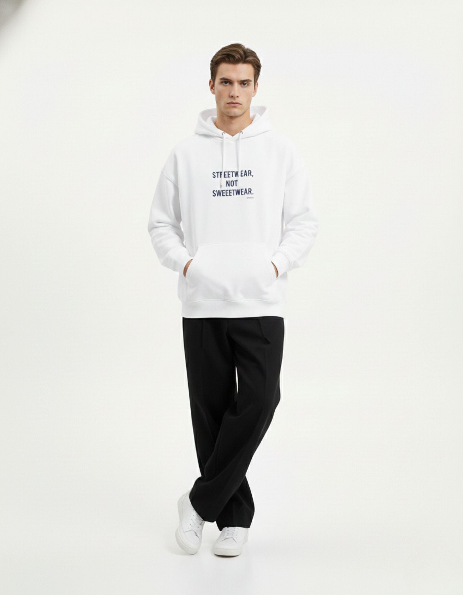 Male model standing wearing the white "STREETWEAR, NOT SWEETWEAR" hoodie, perfect for Gen Z fashion trends.