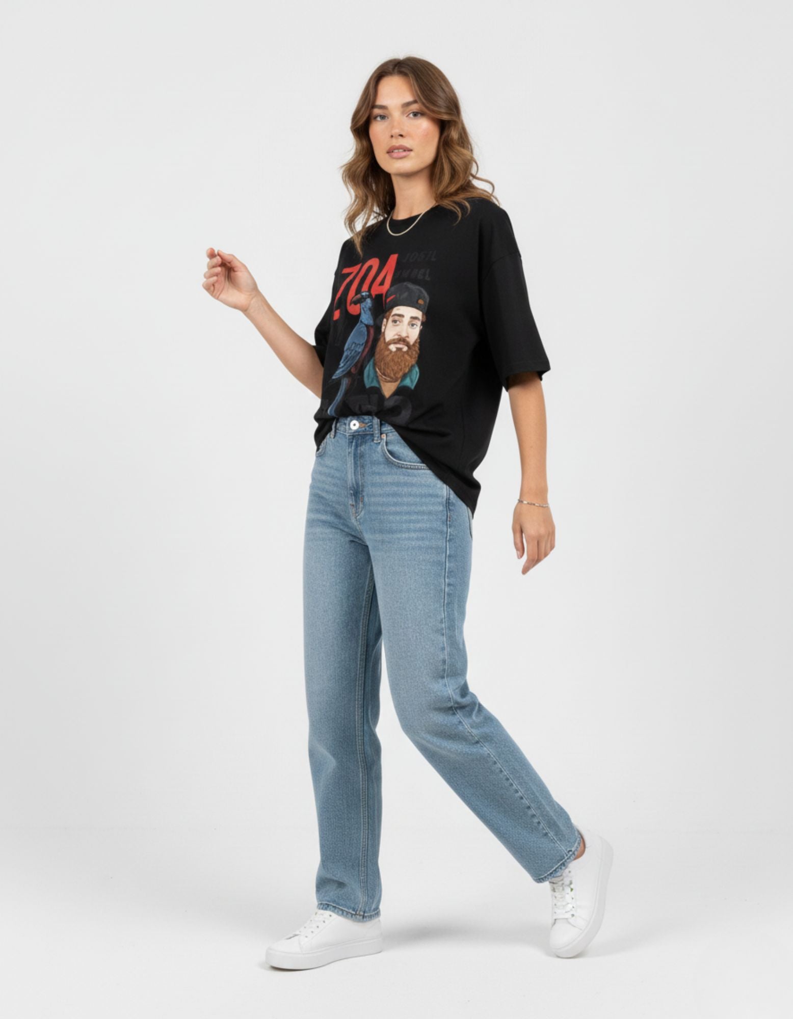 Aesthetic streetwear outfit idea featuring a black oversized graphic t-shirt paired with light blue denim.