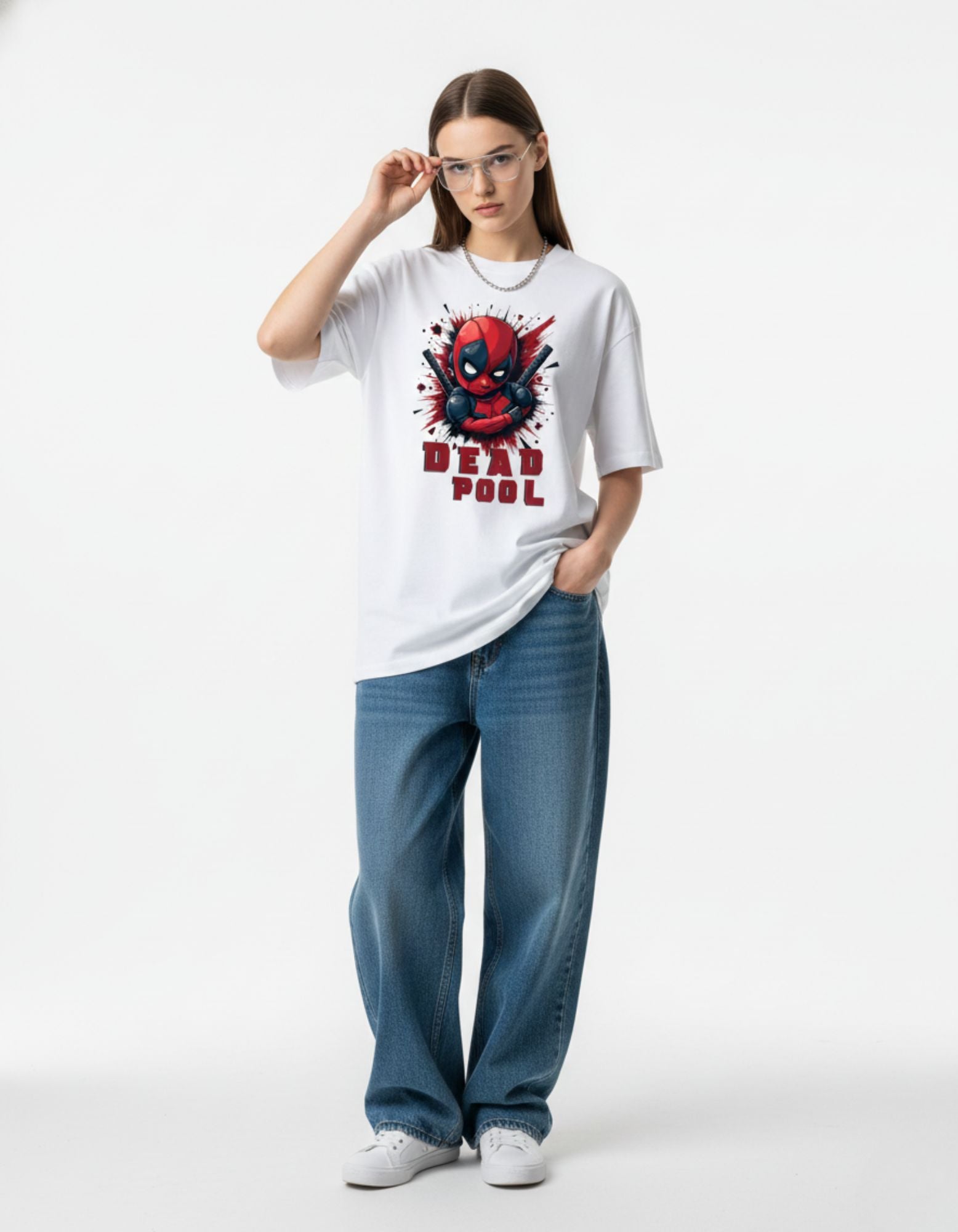 Woman in white oversized Deadpool graphic t-shirt with glasses, showcasing a cool geek-chic streetwear style in India.