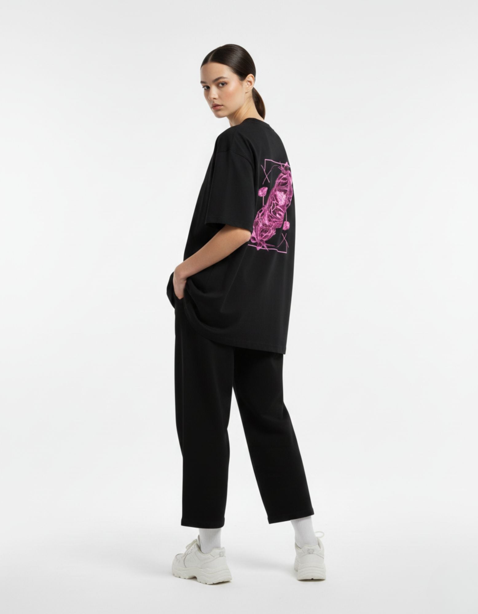 Stylish back-angled view of the GENZs Fashion pink graphic print on a black premium cotton oversized t-shirt.