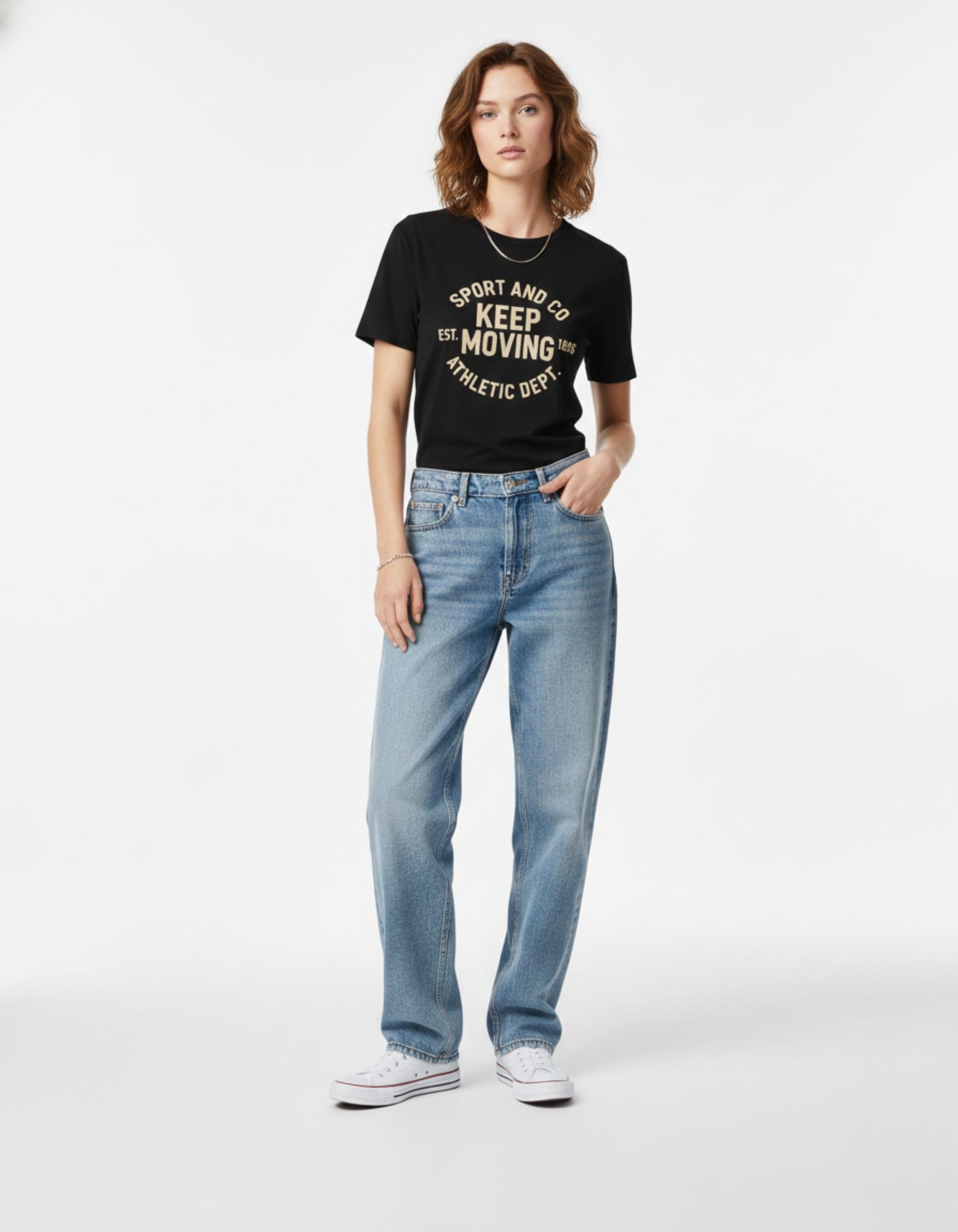 Full-length shot of a female model wearing a black oversized graphic t-shirt, ideal for Gen Z streetwear style in India.