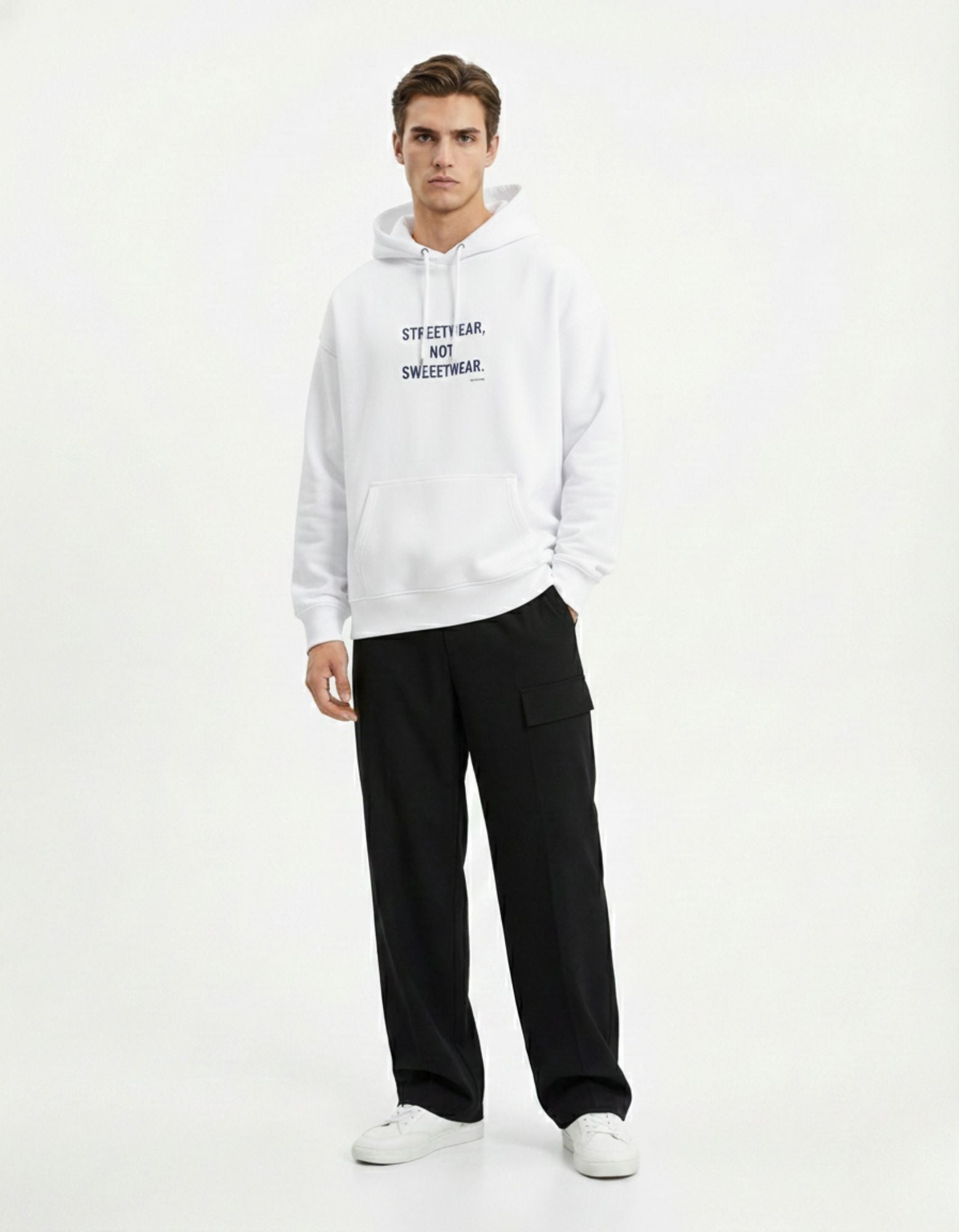 Full body shot of a male model wearing a GENZs Fashion white hoodie and black trousers, a classic minimalist streetwear look.