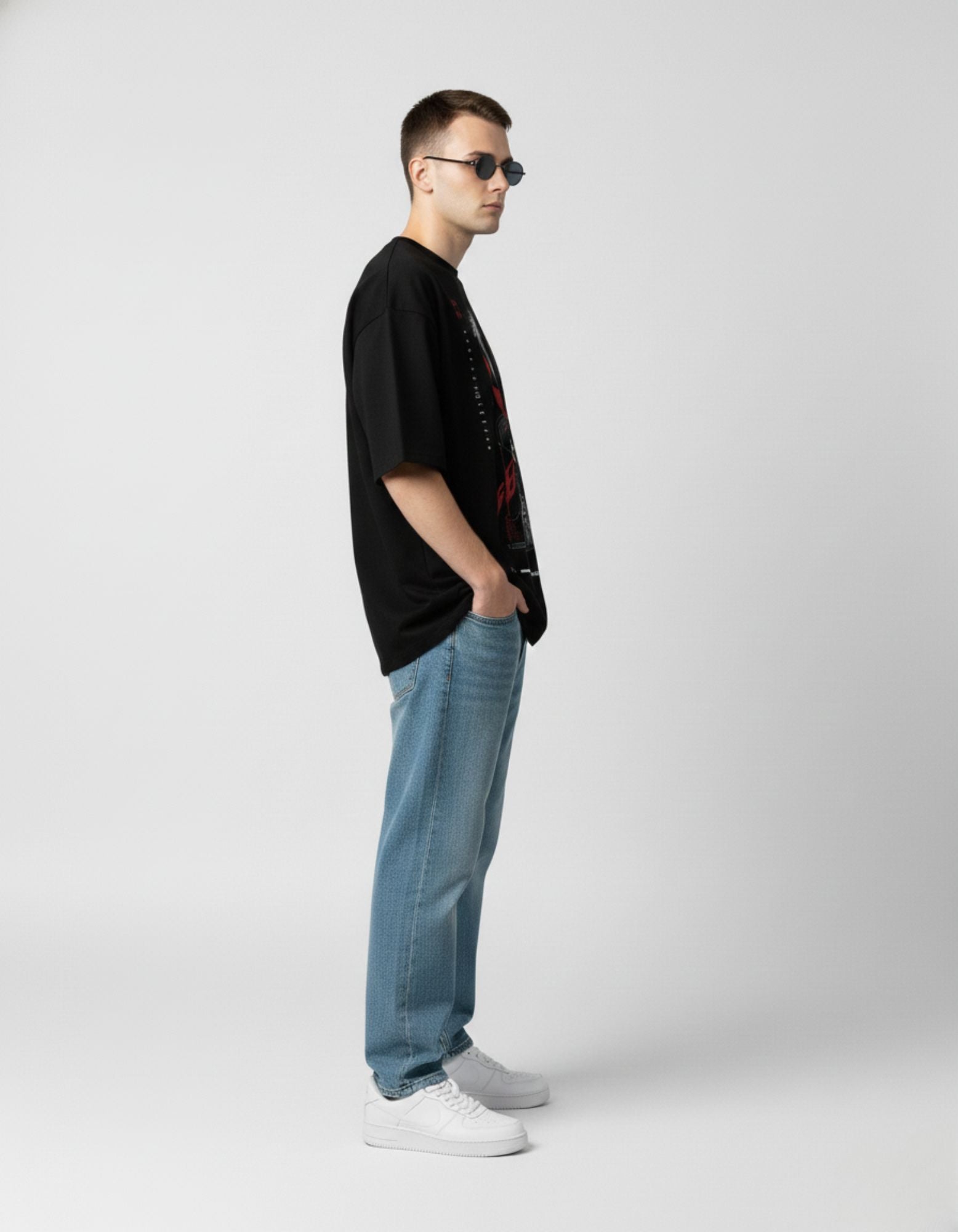 Three-quarter view of a black streetwear t-shirt with a red and white cyberpunk anime character design.