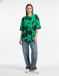 "Women's oversized green and black tie-dye t-shirt, premium baggy streetwear for urban fashion in India."