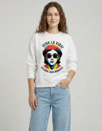 Female model standing in a white 'VIVA LA VIDA' sweatshirt featuring a vibrant, colorful pop-art face graphic.