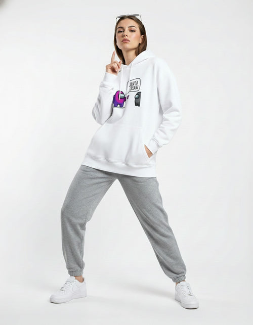 Female model wearing a white Among Us graphic hoodie with a purple character and 'He's Sus!' text, styled with gray joggers.
