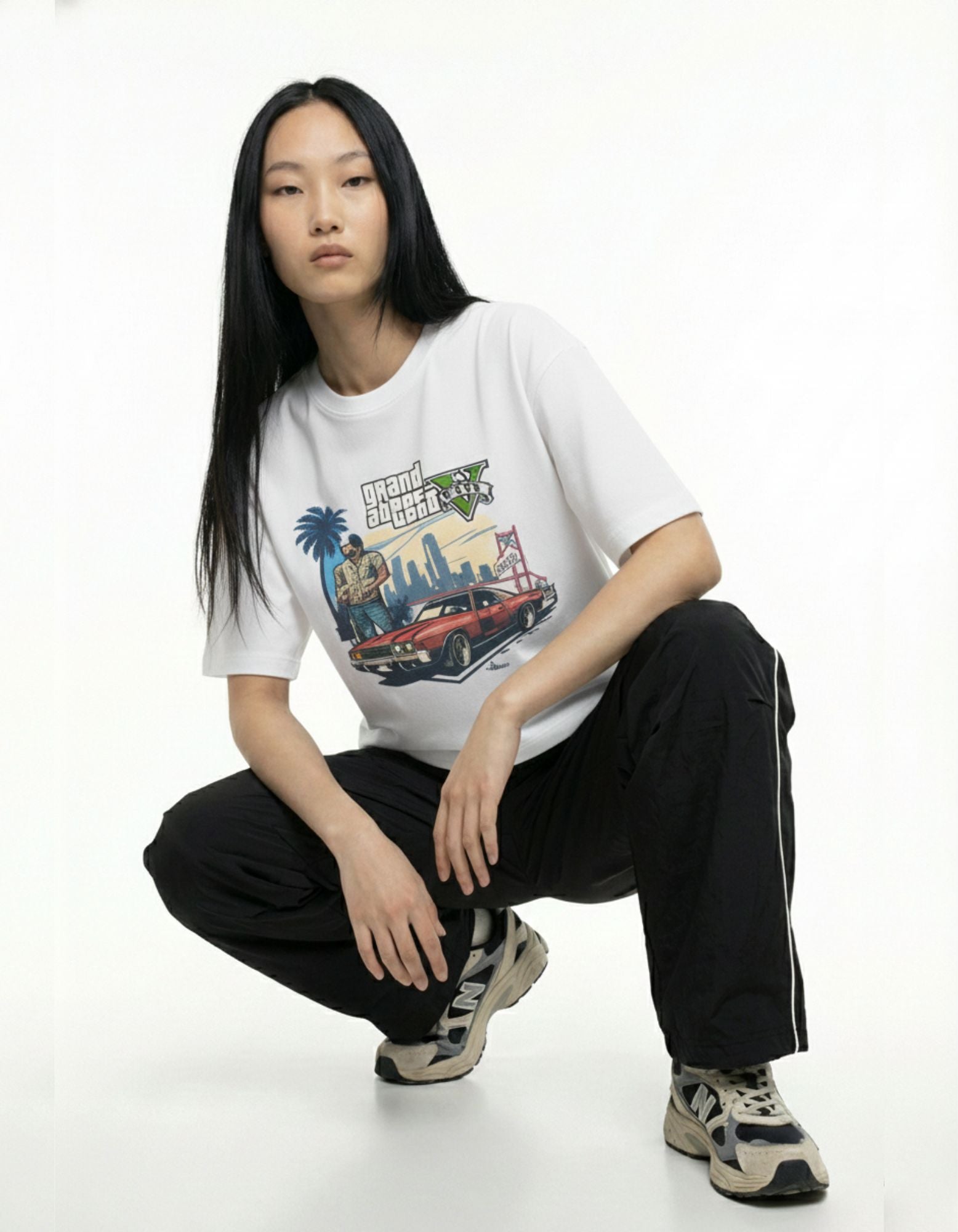 Street-style pose of woman in white boxy fit graphic t-shirt, trendy oversized tee India.