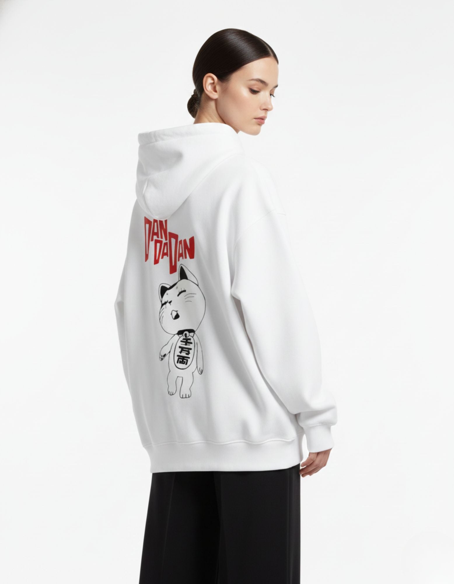 Back view of female model in a white GENZs Fashion hoodie with the Dandadan anime cat character and red logo print.