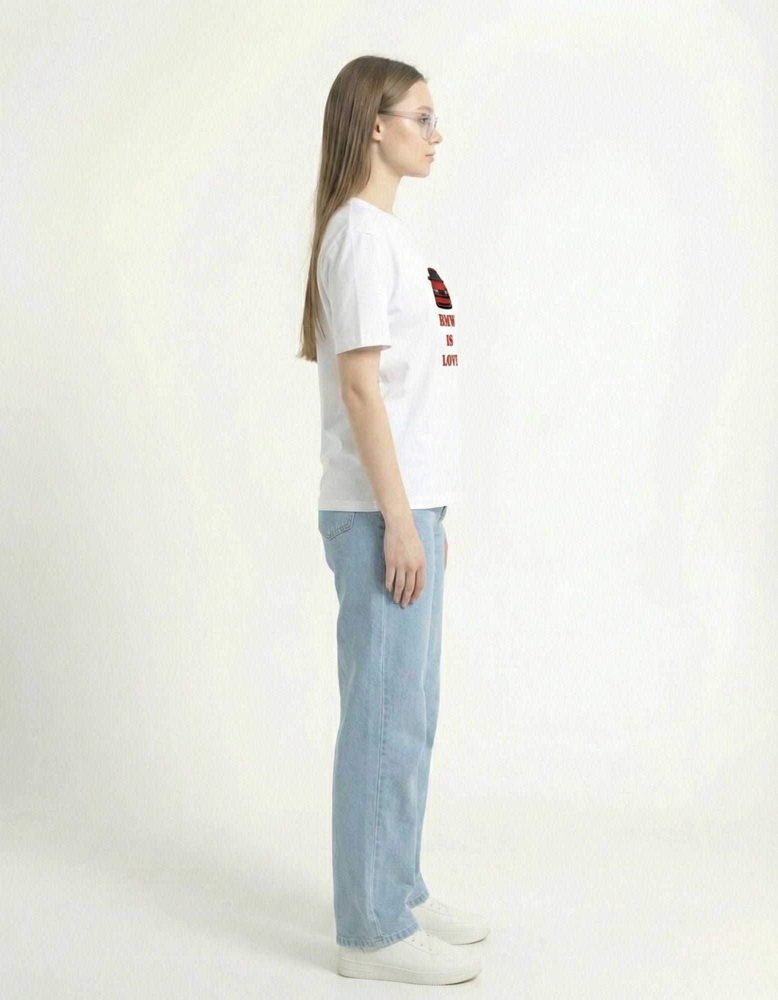 Side profile of the white BMW graphic t-shirt showing the sleeve length and comfortable streetwear silhouette.