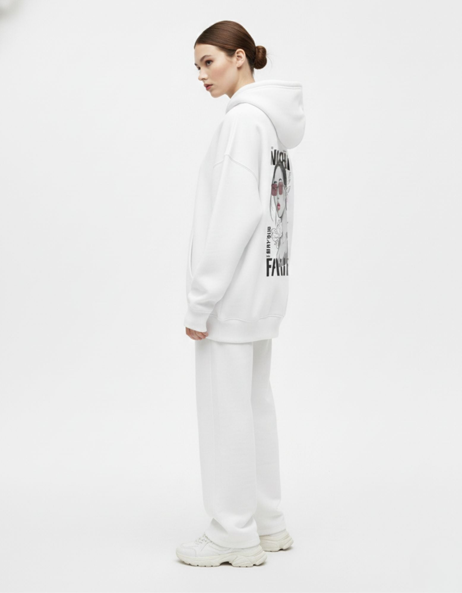 Side view of a model wearing a white heavyweight cotton tracksuit set, showcasing the oversized fit and premium drape.