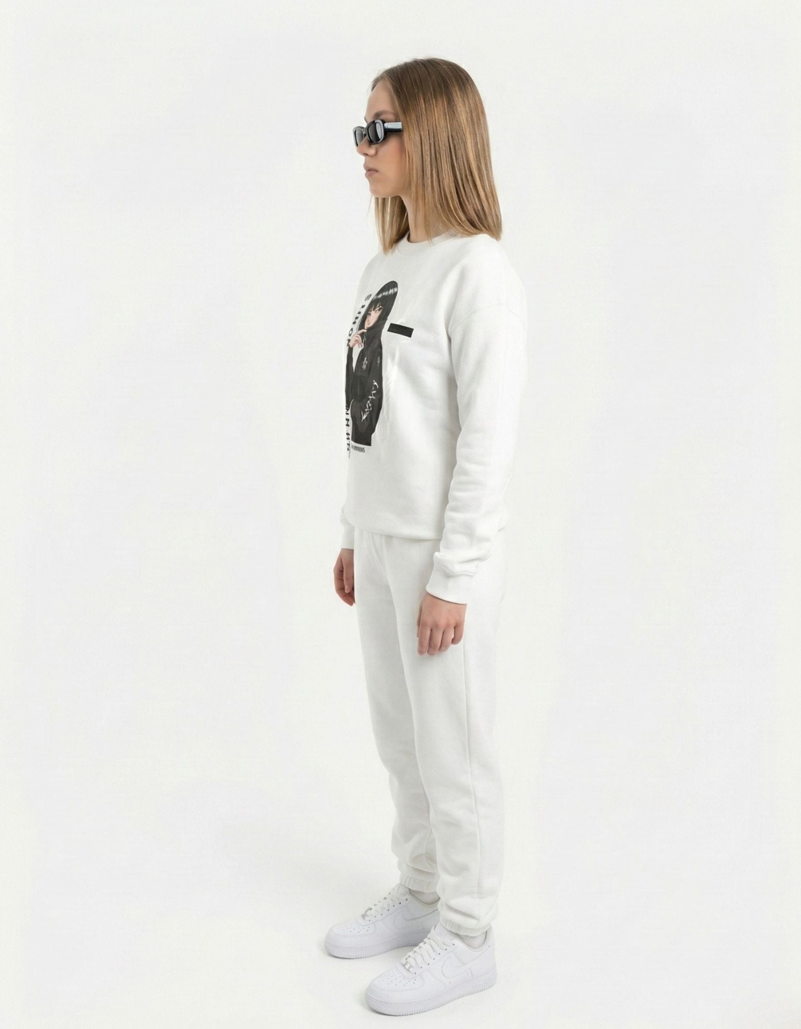 Side profile of a female model wearing a minimalist anime art sweatshirt, showcasing the premium oversized fit for streetwear enthusiasts.